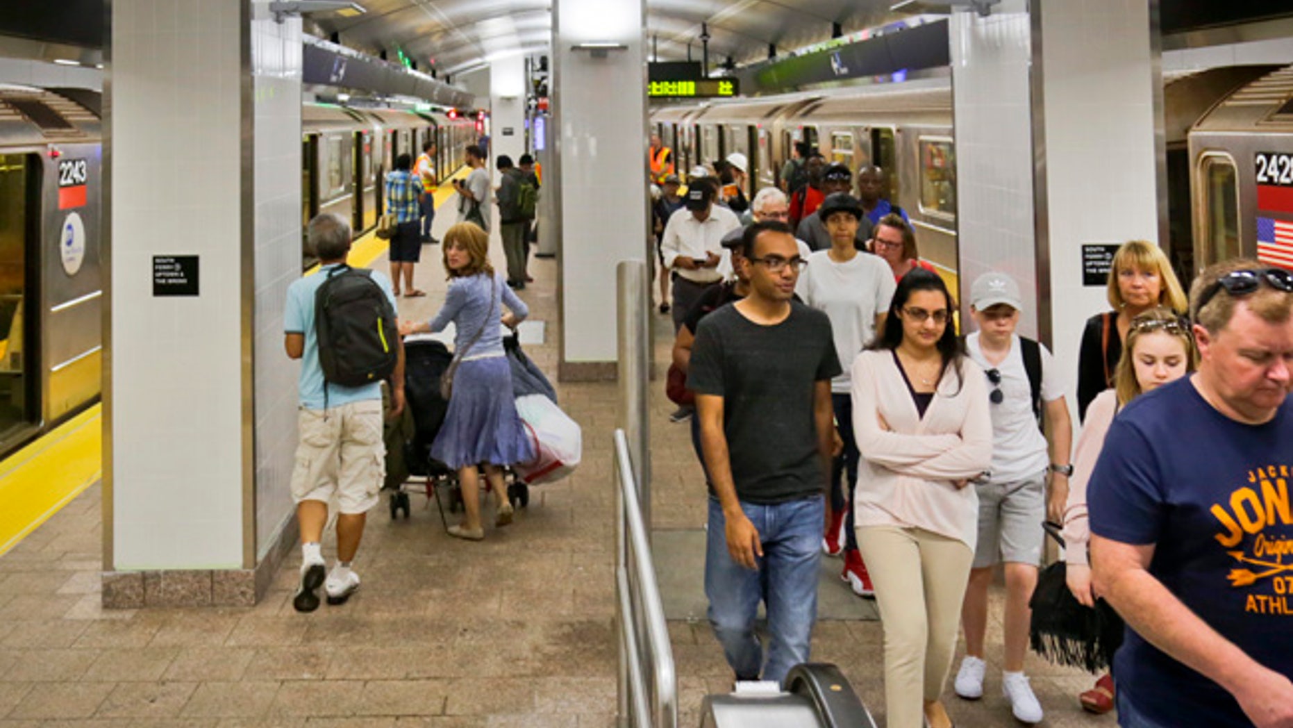Passengers leave the No. 1 train at the South Ferry Station, Tuesday June 27, 2017, in New York. The station reopened Tuesday, nearly five years after it was flooded by Superstorm Sandy in October 2012. (AP Photo/Bebeto Matthews)