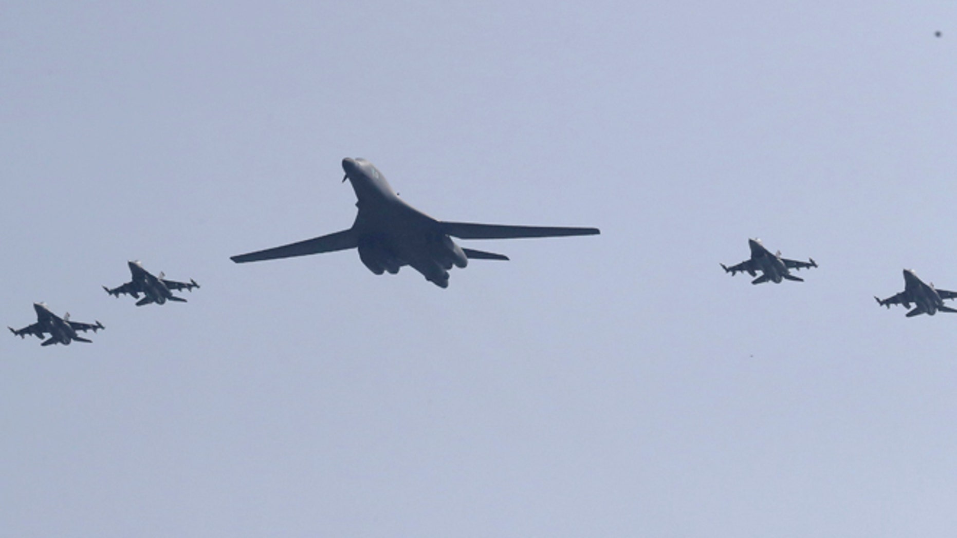 U.S. B-1 bomber, center, flies over Osan Air Base with U.S. jets in Pyeongtaek, South Korea, Tuesday, Sept. 13, 2016.