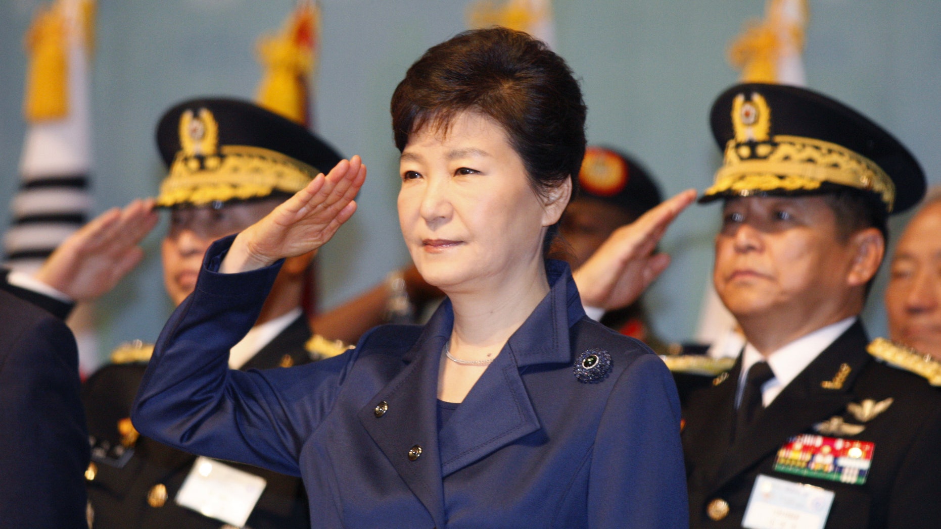 South Korean President Park Geun-hye, center, gives a salute during the 67th Armed Forces Day at Gyeryongdae, South Korea's main compound in Gyeryong City, South Korea, Oct. 1, 2015. (Kim Hee-chul/Pool Photo via AP)