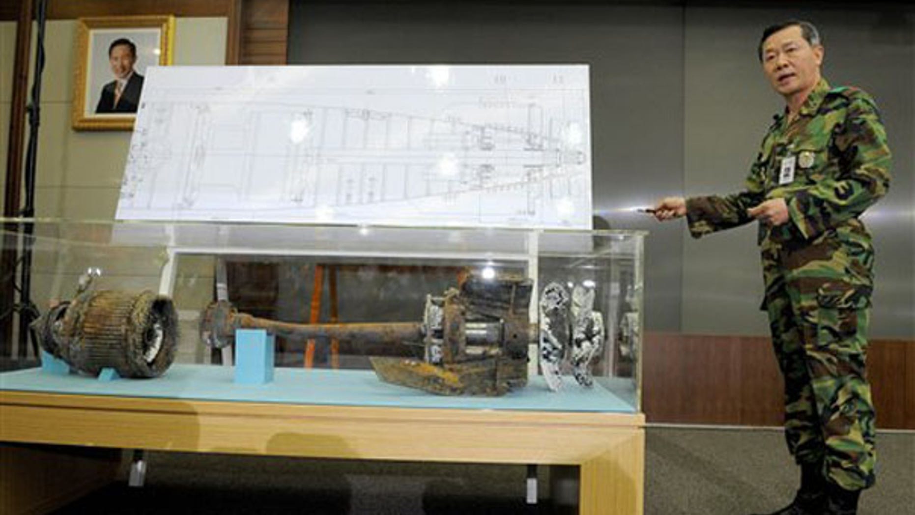 A South Korean military officer shows torpedo parts salvaged from the Yellow Sea during a press conference in Seoul May 20. (AP Photo)