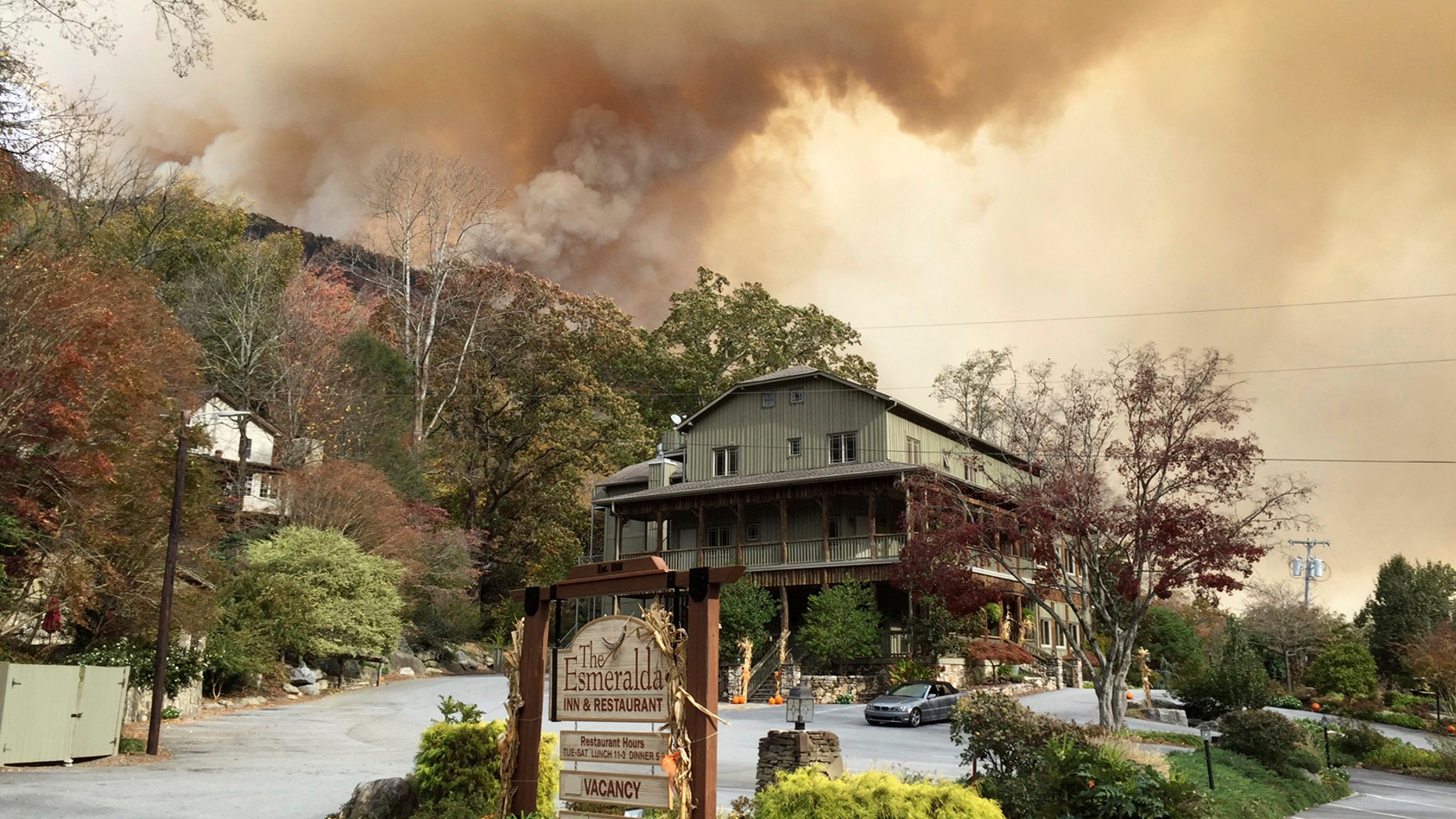 This photo made available by Don Cason shows his business, The Esmeralda Inn and Restaurant, which was evacuated due to the proximity of wildfires, Friday, Nov. 11, 2016 in Lake Lure, N.C. Cason had his 125-year-old inn in the western North Carolina mountains booked solid, rooms full and restaurant reservations lined up, for Veterans Day weekend. (Don Cason via AP)