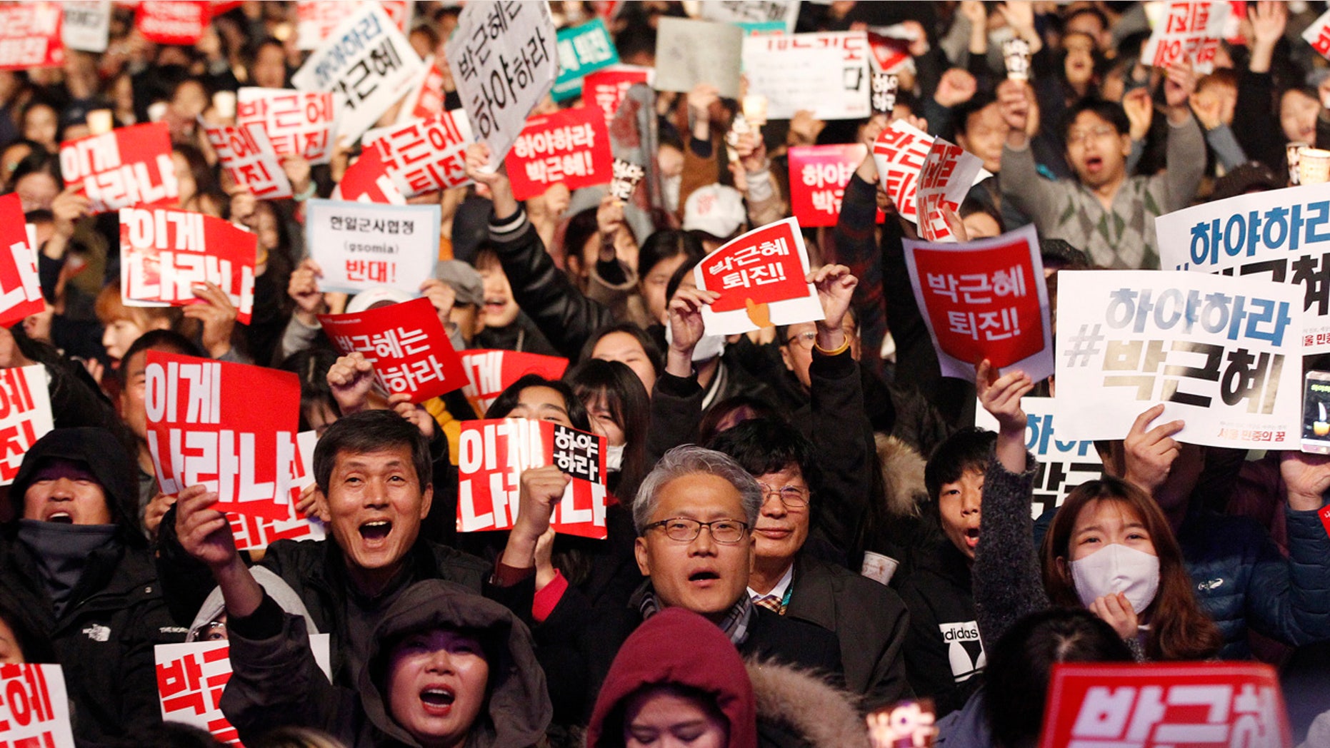 Nov. 5, 2016: Protesters shout slogans during a rally calling for South Korean President Park Geun-hye to step down in downtown Seoul, South Korea. The signs read "Park Geun-hye should step down."