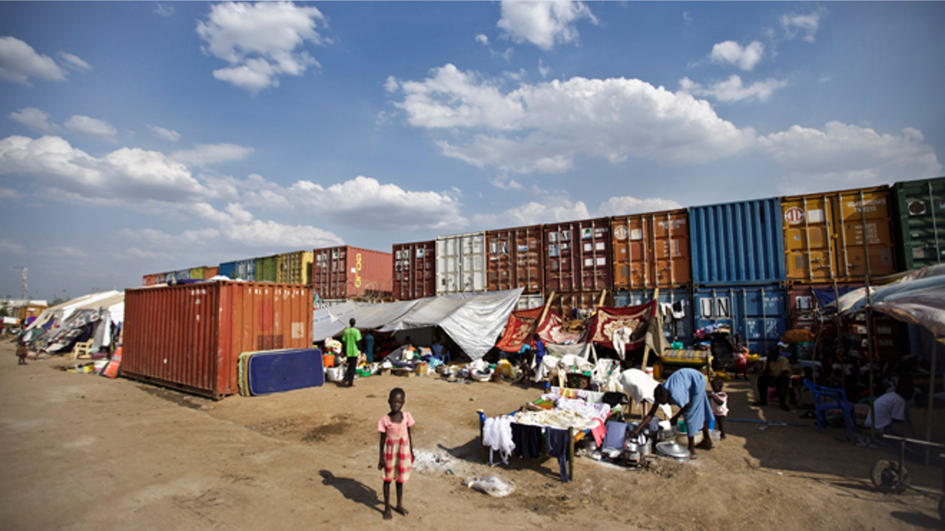 Dec. 29, 2013: In this file photo, a displaced child stands in front of the makeshift tents where she and others live next to shipping containers at a United Nations compound which has become home to thousands of people displaced by the recent fighting, in the capital Juba, South Sudan.