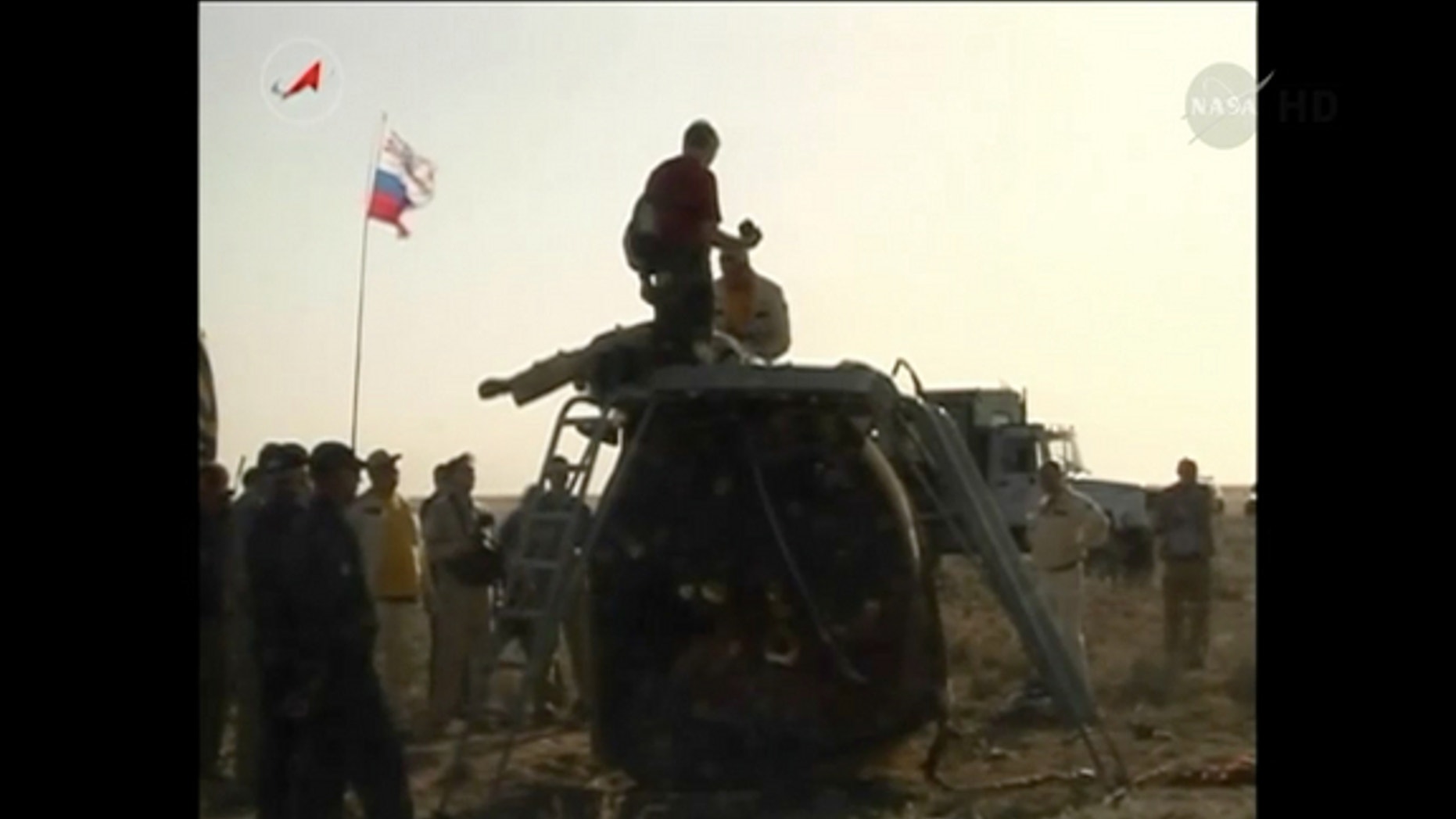 A Russian Soyuz capsule carrying three astronauts rests on the ground after landing in Kazakhstan on May 13, 2014.