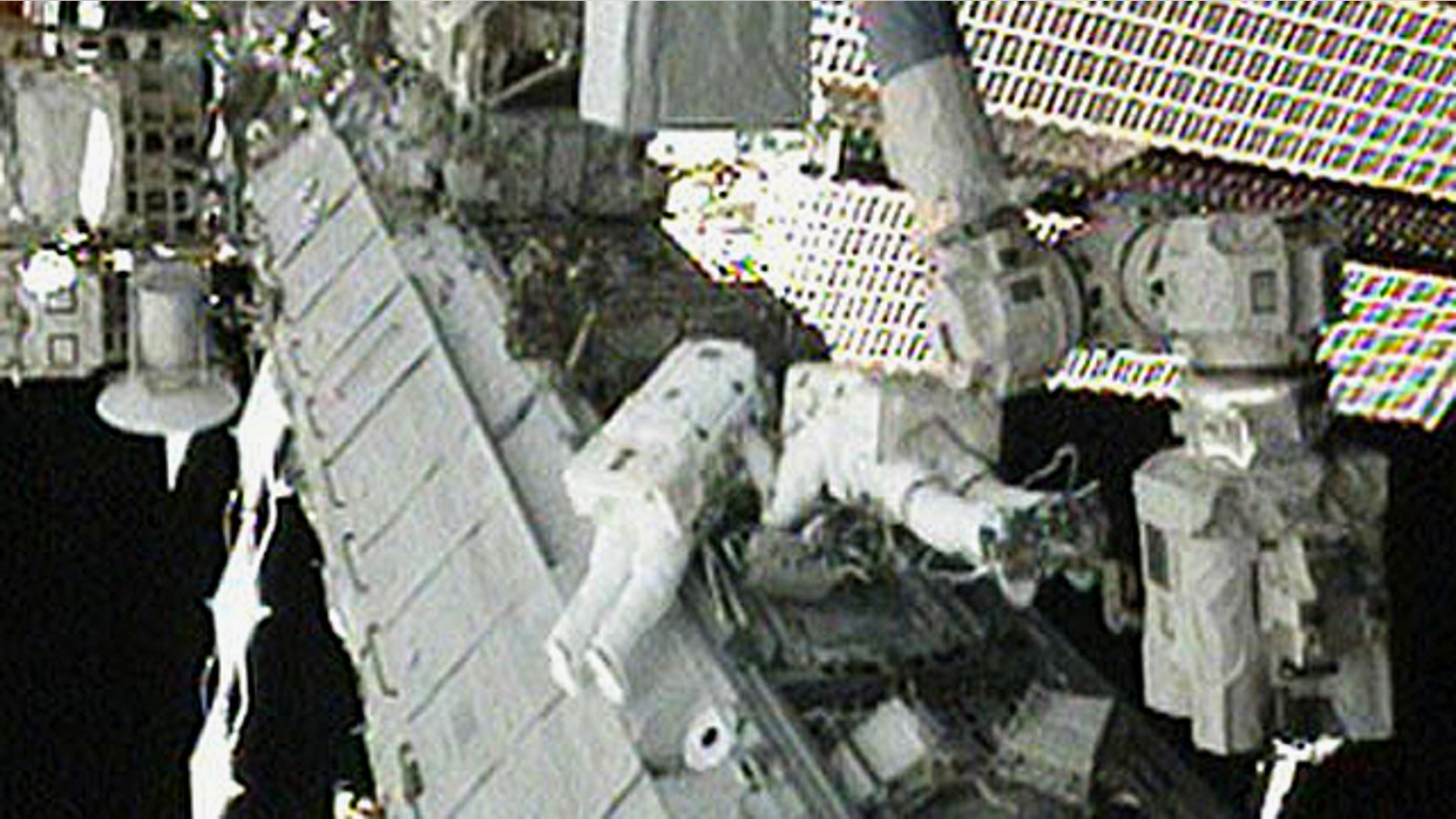NASA astronauts Tracy Caldwell Dyson (left) and Doug Wheelock work to set up the ammonia spare pump module after it was installed on the S1 Truss during an Aug. 16, 2010 spacewalk outside the International Space Station. It was the third spacewalk dedicated to the repair.