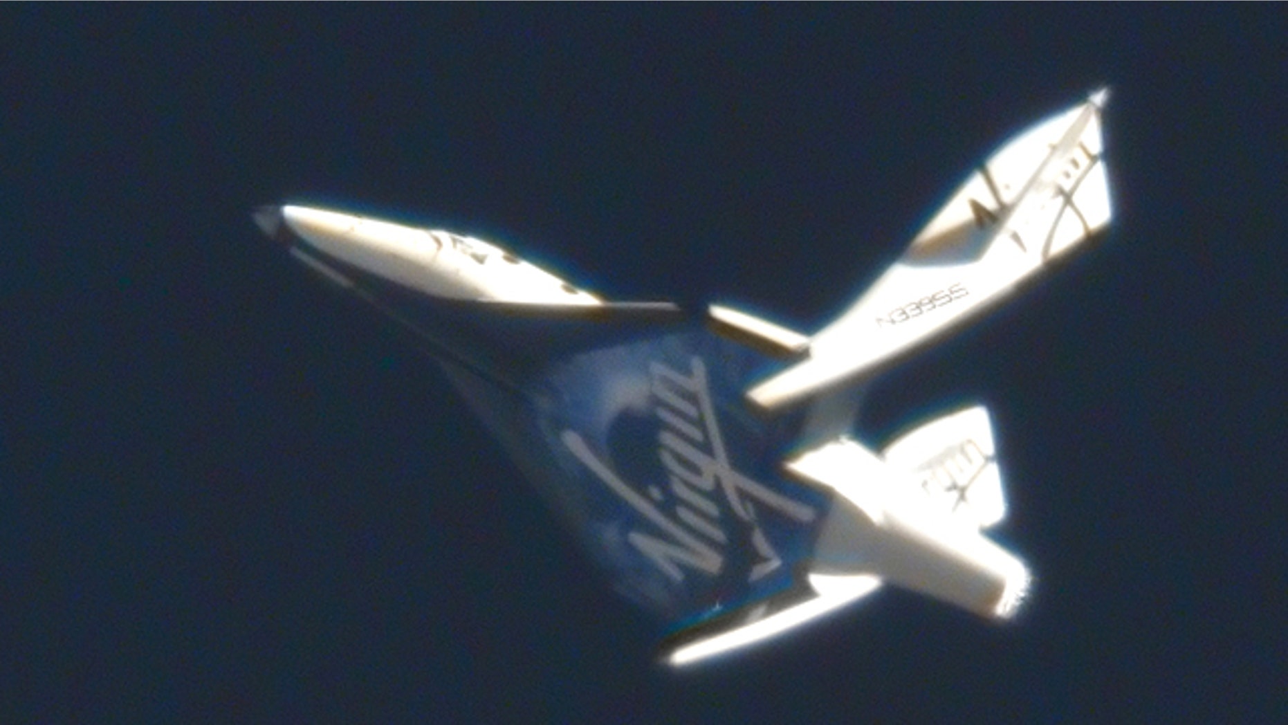 May 4, 2011: Virgin Galactic's suborbital passenger ship SpaceShipTwo flexes its feathered re-entry system during a pivotal glide test at the Mojave Air and Space Port in California.