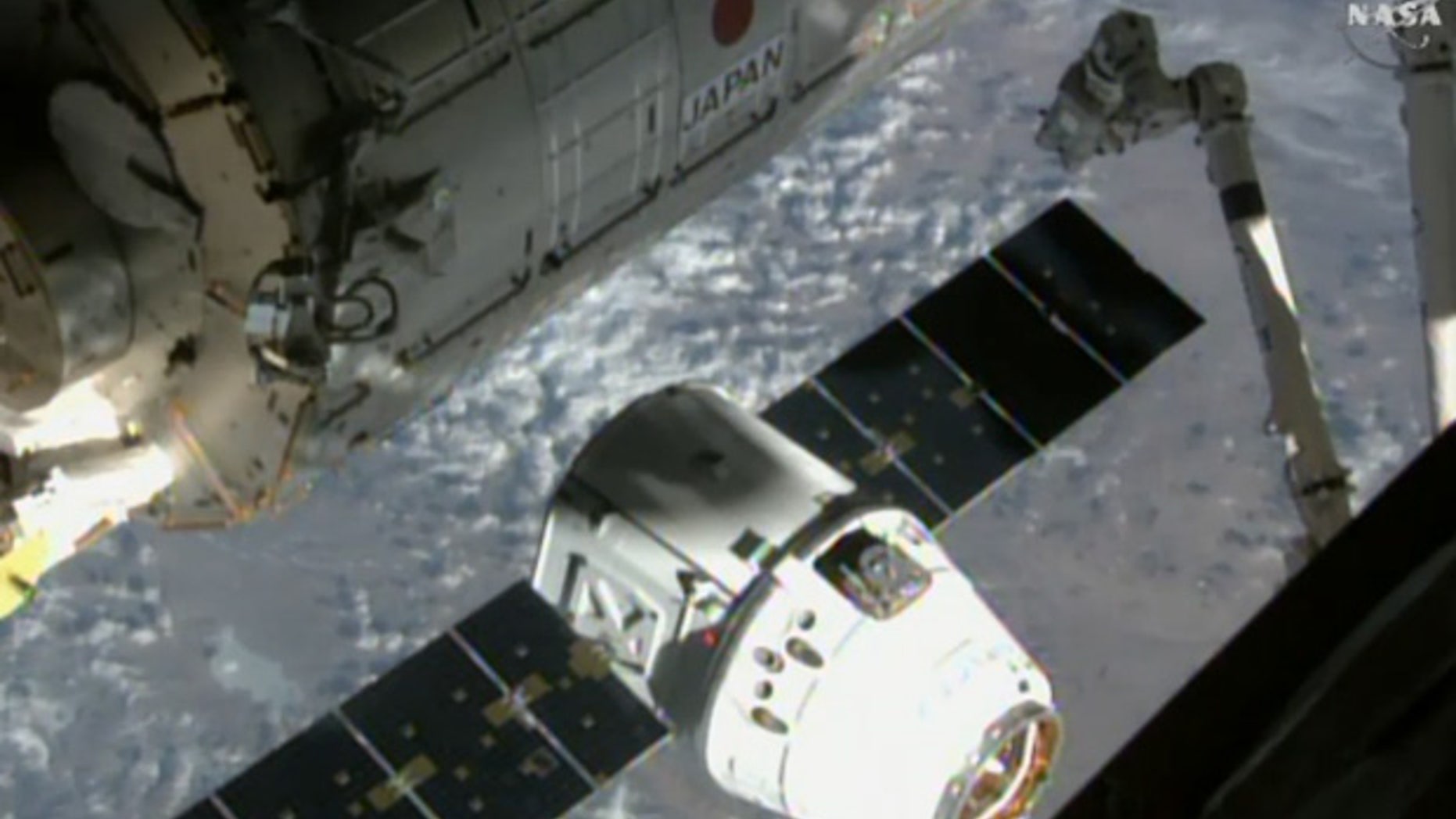 SpaceX’s uncrewed Dragon cargo ship approaches the International Space Station (ISS) on April 17, 2015, in this still from a camera on the orbiting lab’s exterior. This same Dragon arrived at the space station on Dec. 17, 2017.