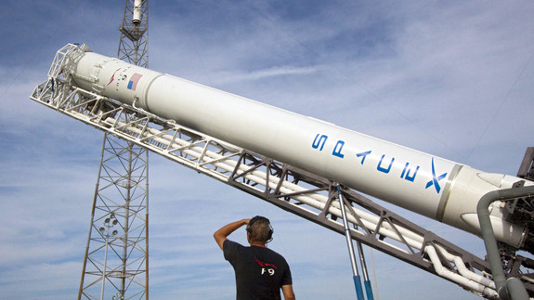 At Space Launch Complex 40 on Cape Canaveral Air Force Station in Florida, the Space Exploration Technologies, or SpaceX, Falcon 9 rocket is moved into a vertical position for a wet dress rehearsal. This image was released Aug. 31, 2012.