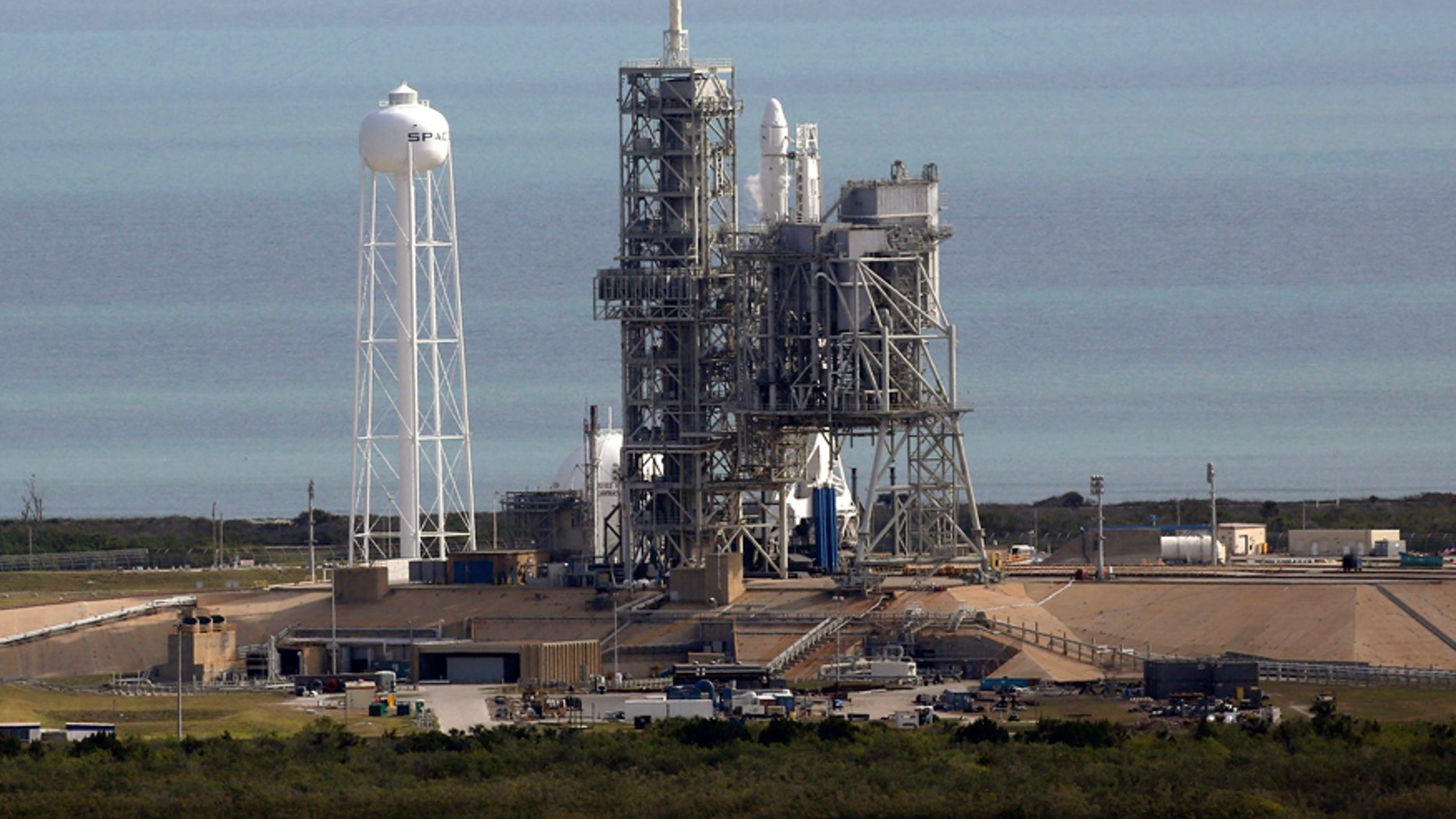 A Space X Falcon9 rocket sits on the launch pad, Saturday, Feb. 18, 2017 at the Kennedy Space Center in Cape Canaveral, Fla Last-minute rocket trouble forced SpaceX on Saturday to delay its inaugural launch from NASA's historic moon pad. SpaceX halted the countdown with just 13 seconds remaining. The problem with the second-stage thrust control actually cropped up several minutes earlier. With just a single second to get the Falcon rocket airborne, flight controllers could not resolve the issue in time. (Red Huber/Orlando Sentinel via AP)