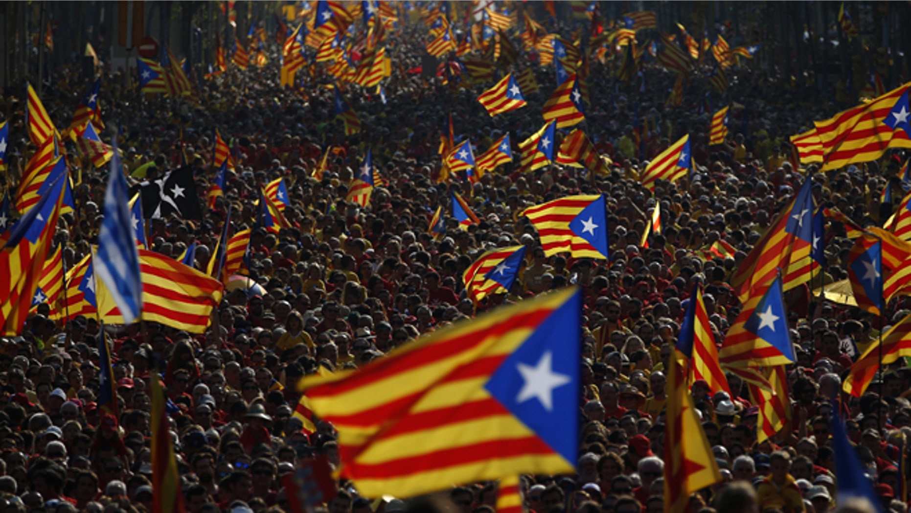 Sept. 11, 2014: Hundreds of thousands of demonstrators stand on the streets waving their estelada flags that symbolizes Catalonia's independence during a protest calling for the independence of Catalonia in Barcelona, Spain.