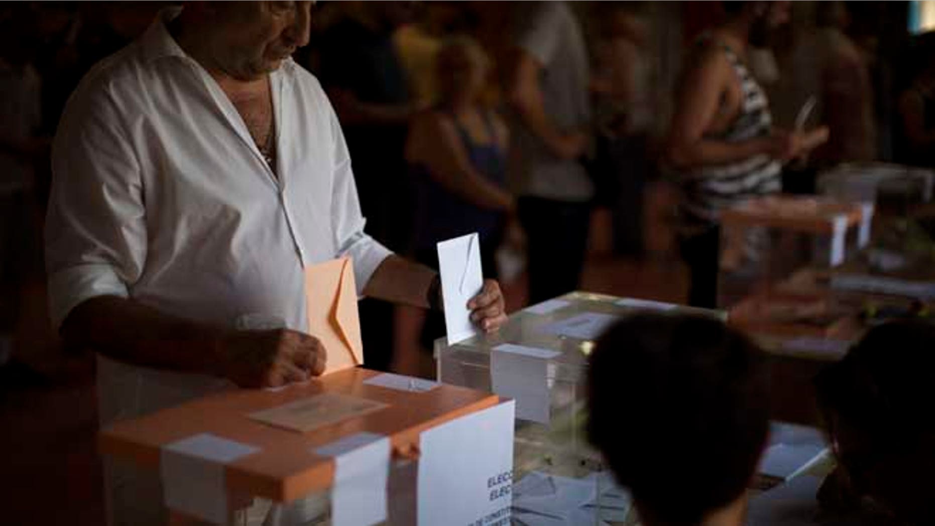 A man casts his vote for the national elections in Barcelona, Spain, Sunday. Spaniards voted Sunday in an unprecedented repeat election that aimed to break six months of political deadlock after a December ballot left the country without an elected government. (AP Photo/Emilio Morenatti)