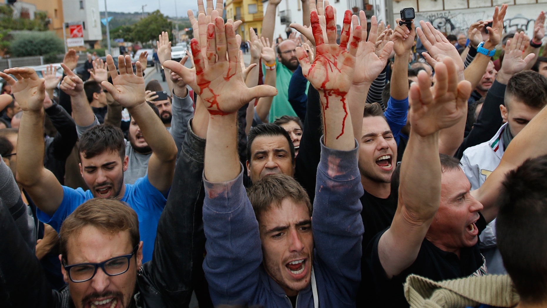 People block the street in a stand off with civil guards in Sant Julia de Ramis, near Girona, Spain, Sunday, Oct. 1, 2017. (AP Photo/Francisco Seco)