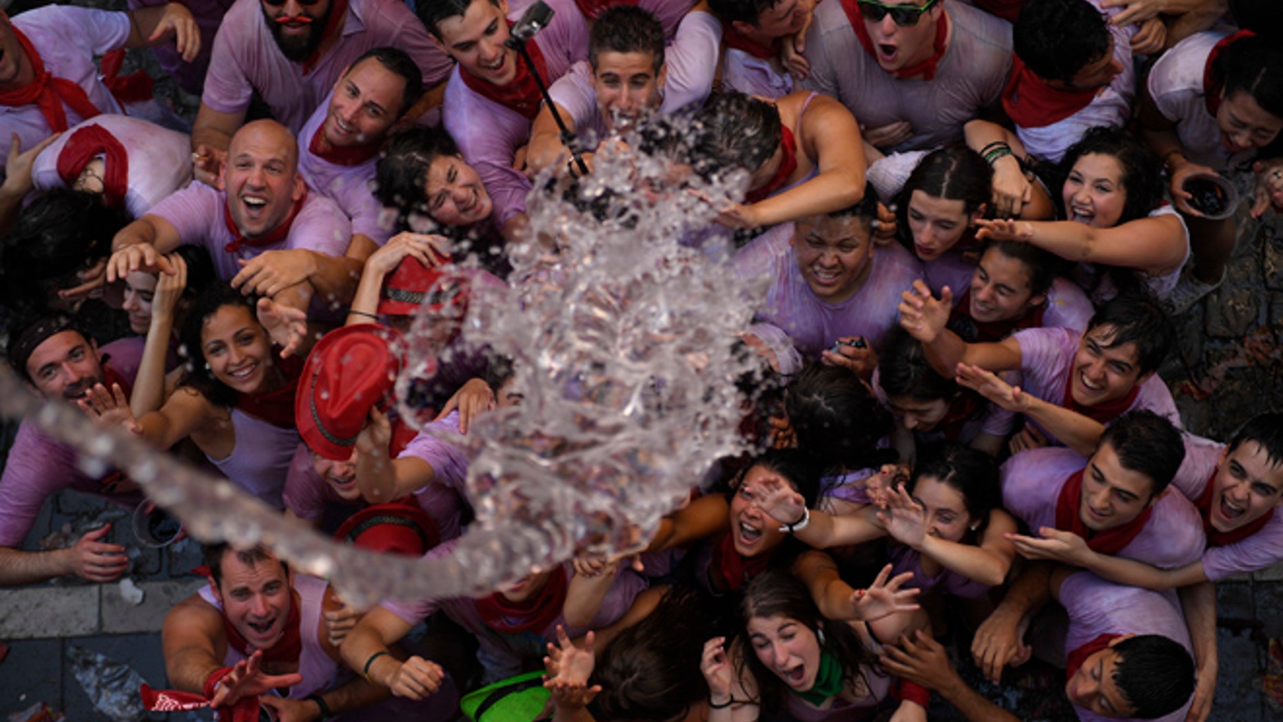 JULY 6: Water is thrown on to revelers during the launch of the ‘Chupinazo’ rocket to celebrate the official opening of the 2016 San Fermin Fiestas.
