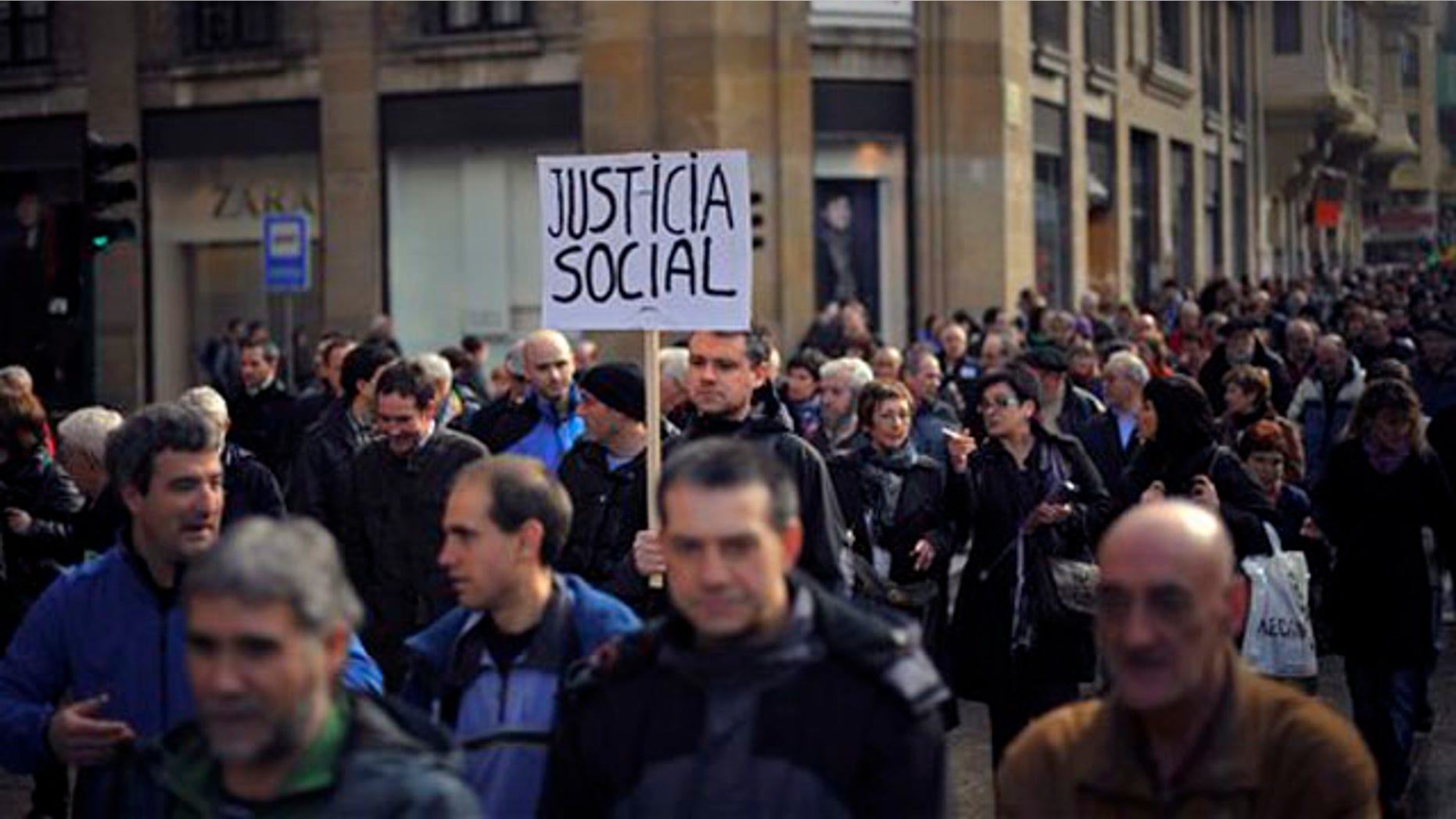 Jan. 21, 2012: A man holds a poster claiming Social Justice during a march to protest against the cuts planned by the conservative Popular Party of Spanish Prime Minister Mariano Rajoy, in Pamplona, northern Spain. The country suffers a strong economic crisis with more than five million unemployed.