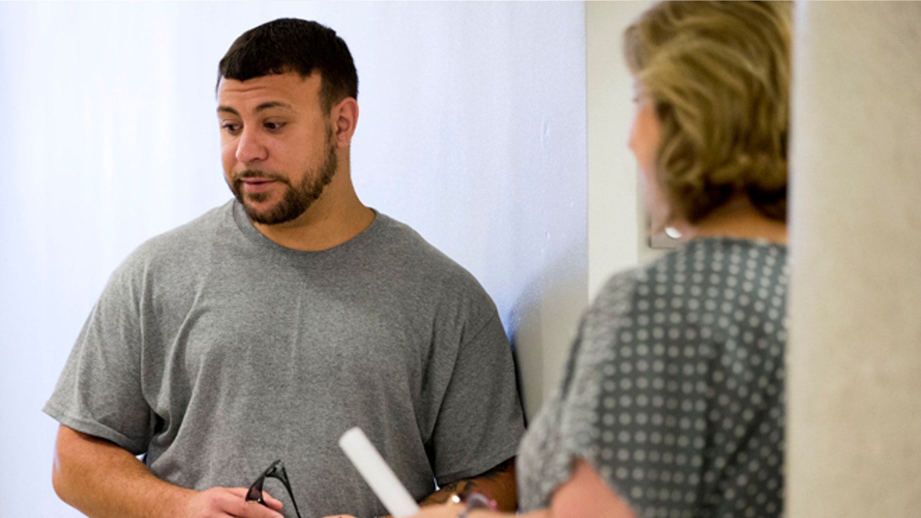 Aug. 21, 2013: This photo shows Iraqi war veteran Paul Piscicelli, left, speaking with Peg Maynard, veterans justice outreach specialist for the Department of Veterans Affairs, at the justice center in Philadelphia.