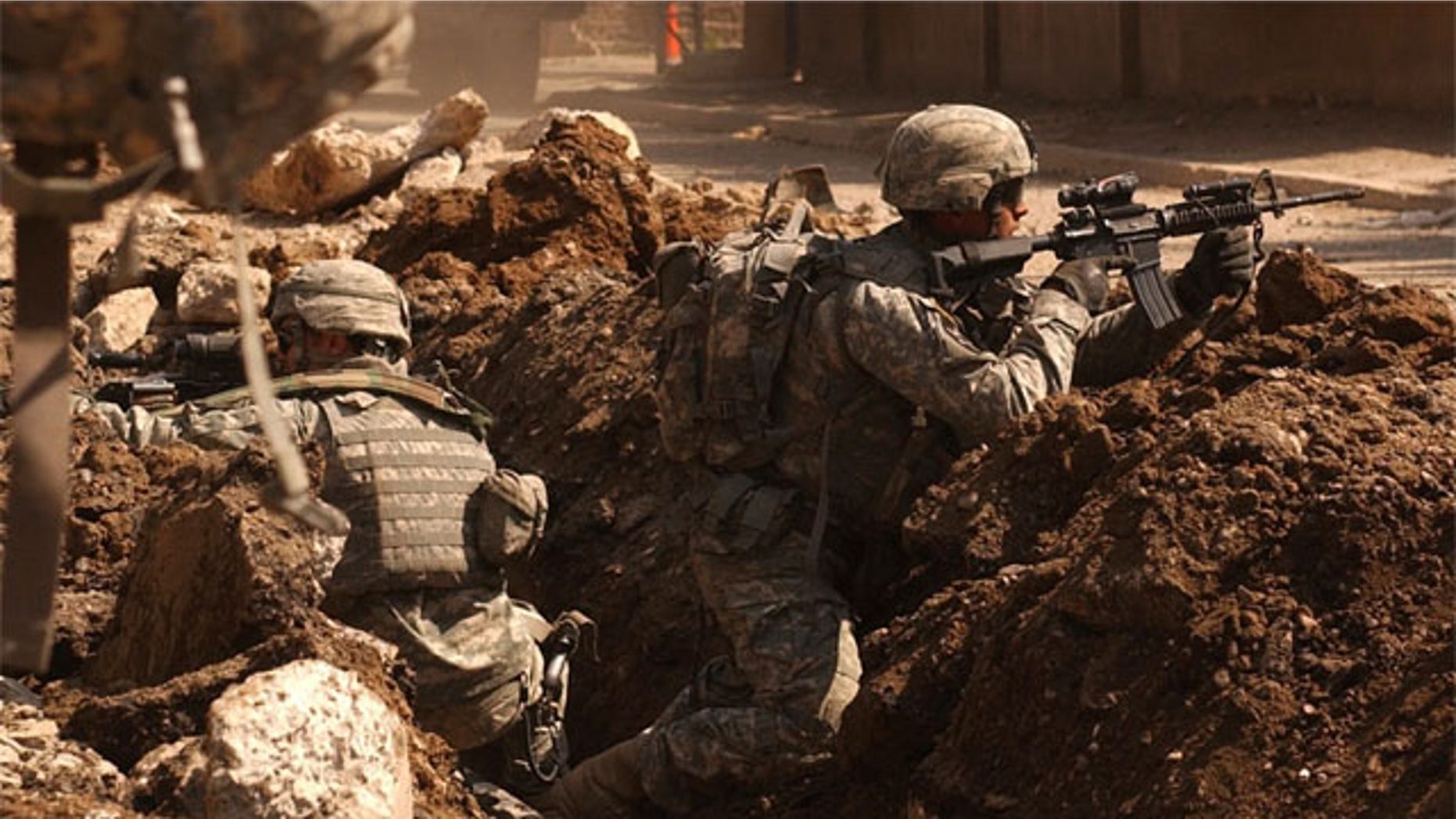 Soldiers occasionally get a sixth sense feeling about battlefield dangers. Here, Sgt. Auralie Suarez and Pvt. Brett Mansink take cover during a firefight with anti-Iraqi forces in the Al Doura section of Baghdad, March 7.
