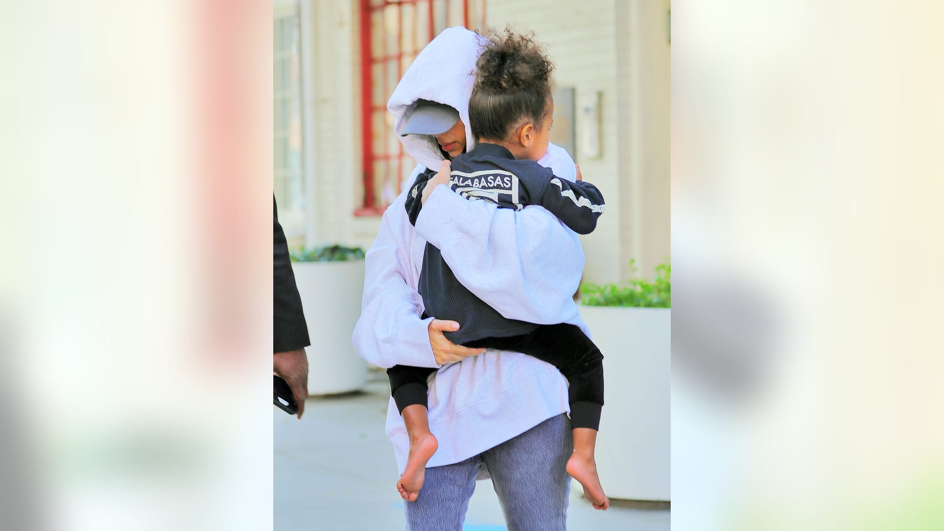 Kim Kardashian runs to her waiting SUV with North West in New York.