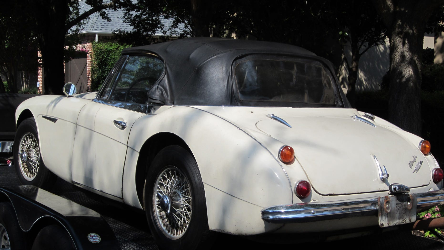 In this image provided by the Los Angeles County Sheriff's Department the stolen car sits on small transport trailer as it is delivered to Robert Russell 's home in Texas.