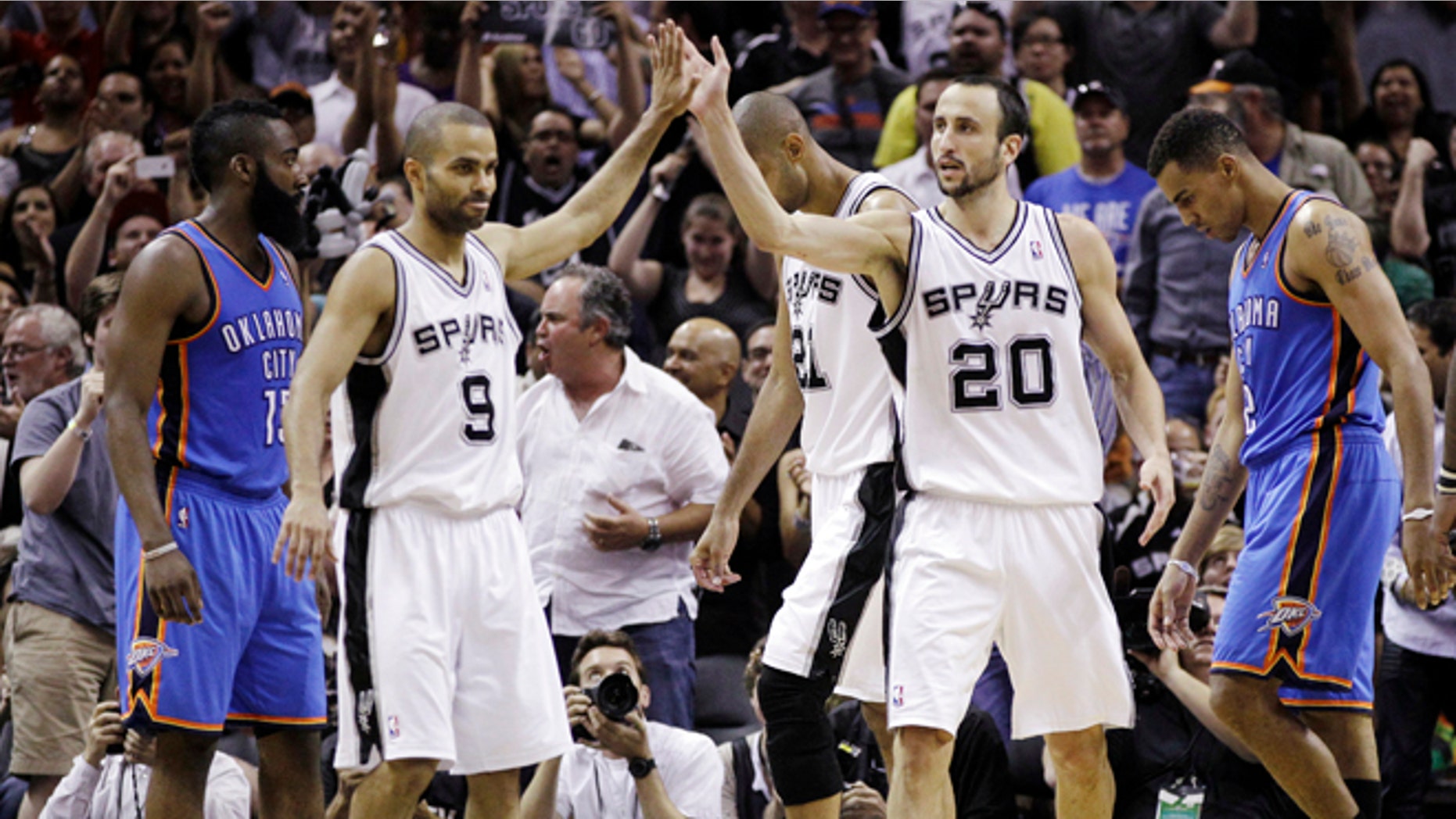 San Antonio Spurs point guard Tony Parker (9), of France, and Manu Ginobili (20) celebrate in front of Oklahoma City Thunder guard James Harden, left, and Thabo Sefolosha, right, during the second half of Game 1 in their NBA basketball Western Conference finals playoff series, Sunday, May 27, 2012, in San Antonio. San Antonio won 101-98. (AP Photo/Eric Gay)