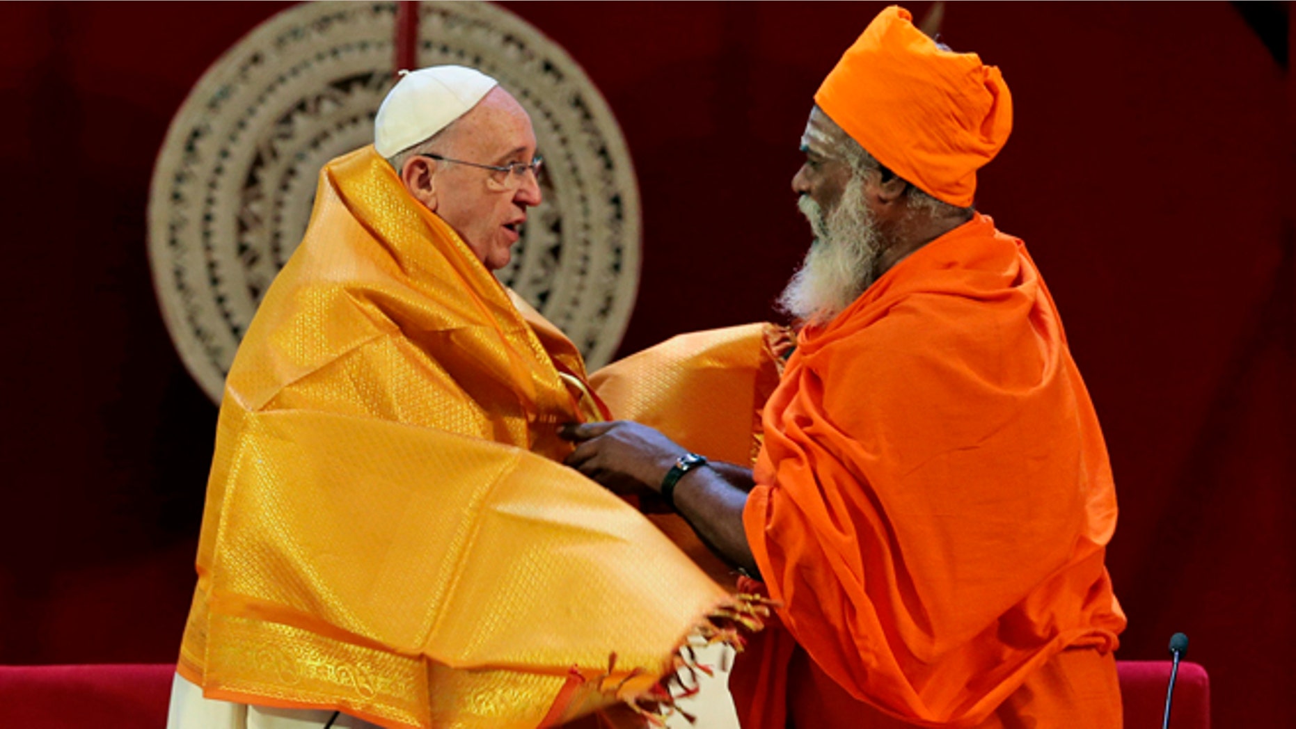 Jan. 13, 2015: Sri Lankan Hindu priest Kurakkal Somasundaram, right, presents a shawl to Pope Francis during an inter-religious meeting in Colombo, Sri Lanka.