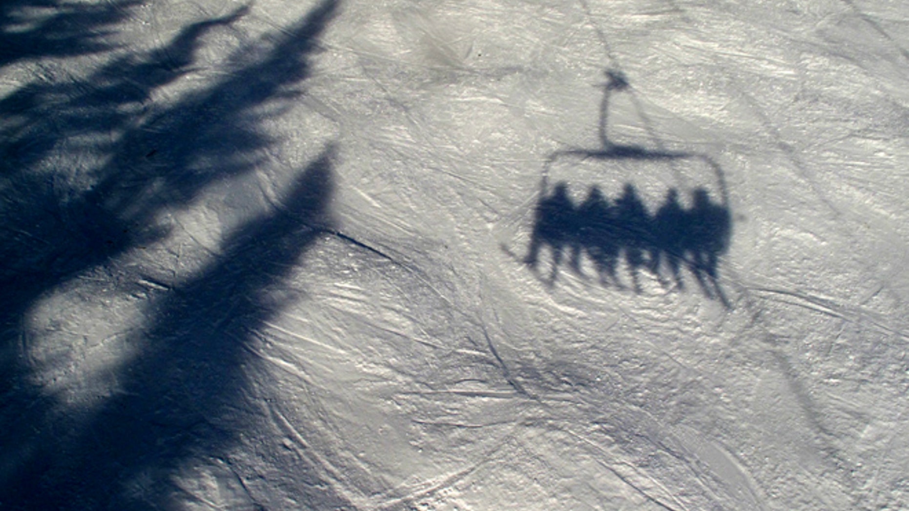 Skiers ride a chairlift up the mountain in Lake Louise in Canada