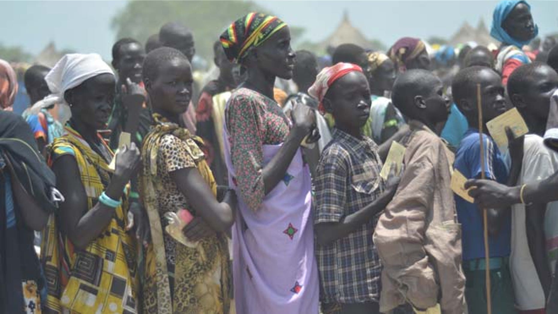 July 25: People waiting for food distribution in Dablual. Soldiers believed to be South Sudanese government troops and allied militia stole relief food and killed seven people in an attack in a rebel-held part of Unity state, a local official said.