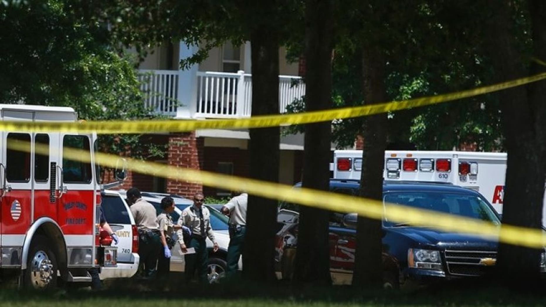 Shelby County Sheriffs deputies work the scene where four young children were fatally stabbed at the Greens of Irene apartment, Friday, July 1, 2016 in Memphis, Tenn.