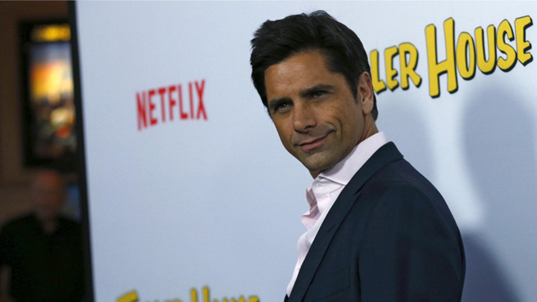 February 16, 2016. John Stamos poses at the premiere for the Netflix television series "Fuller House" in Los Angeles.