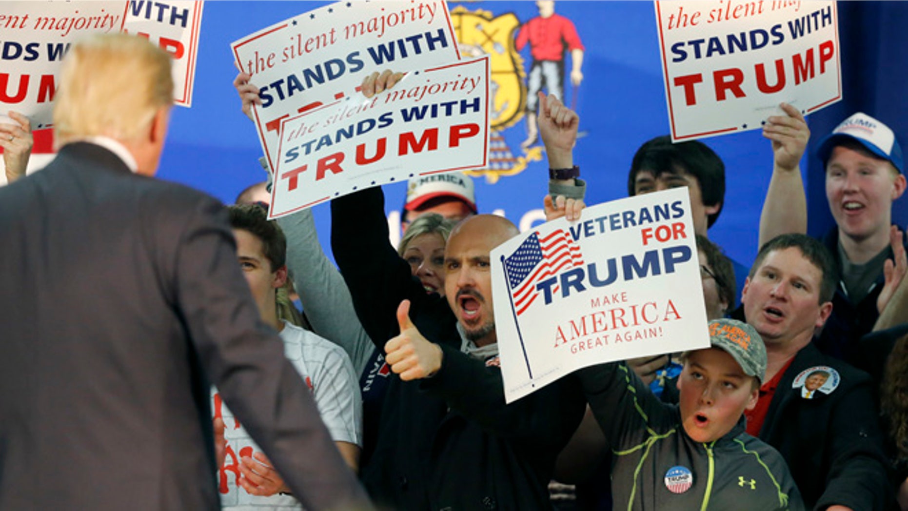 FILE - In this Saturday, April 2, 2016 file photo, a supporter of Republican presidential candidate Donald Trump gives him a thumbs up during a town hall in Rothschild, Wis. (AP Photo/Charles Rex Arbogast, File)