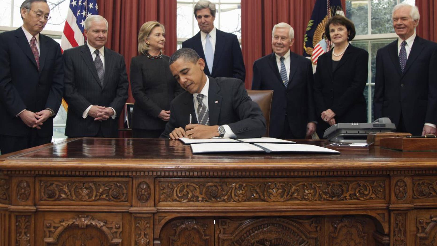 President Barack Obama signs the New START Treaty in the Oval Office of the White House in Washington, Wednesday, Feb. 2, 2011. (AP Photo/Carolyn Kaster)