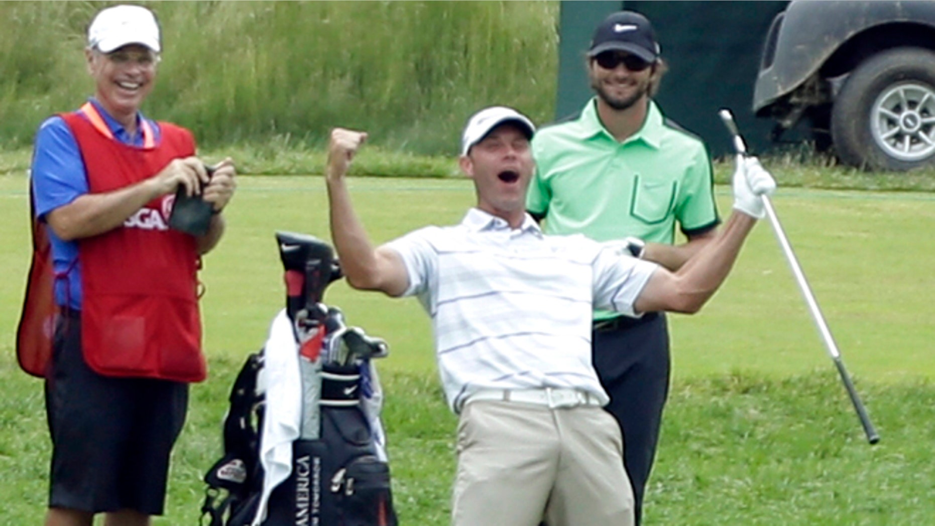 June 16, 2013: Shawn Stefani, center, reacts after hitting a hole in one on the 17th hole during the fourth round of the U.S. Open golf tournament at Merion Golf Club, in Ardmore, Pa.