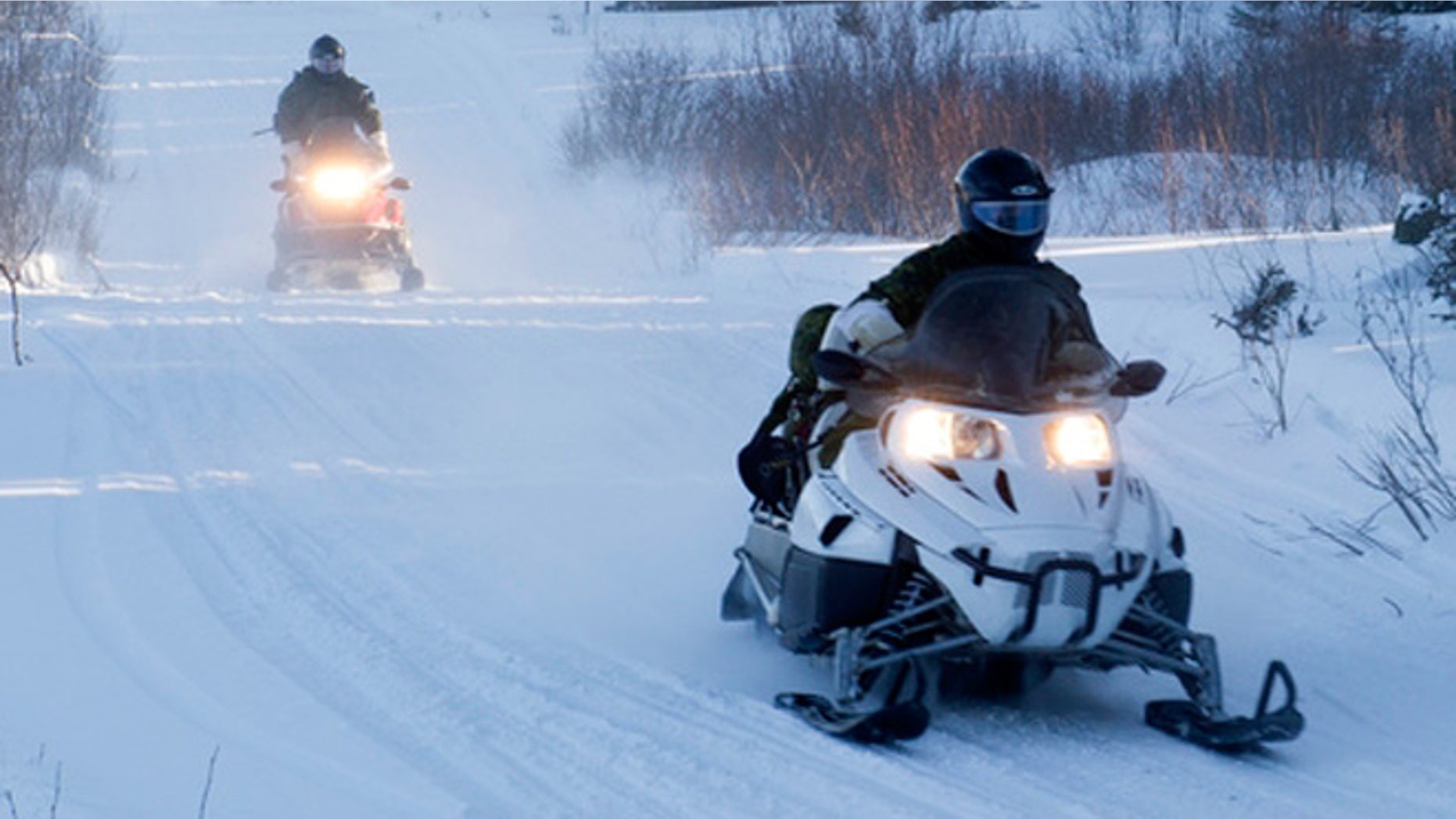 Members of the Arctic Response Company Group conducting exercises on conventional snow mobiles.