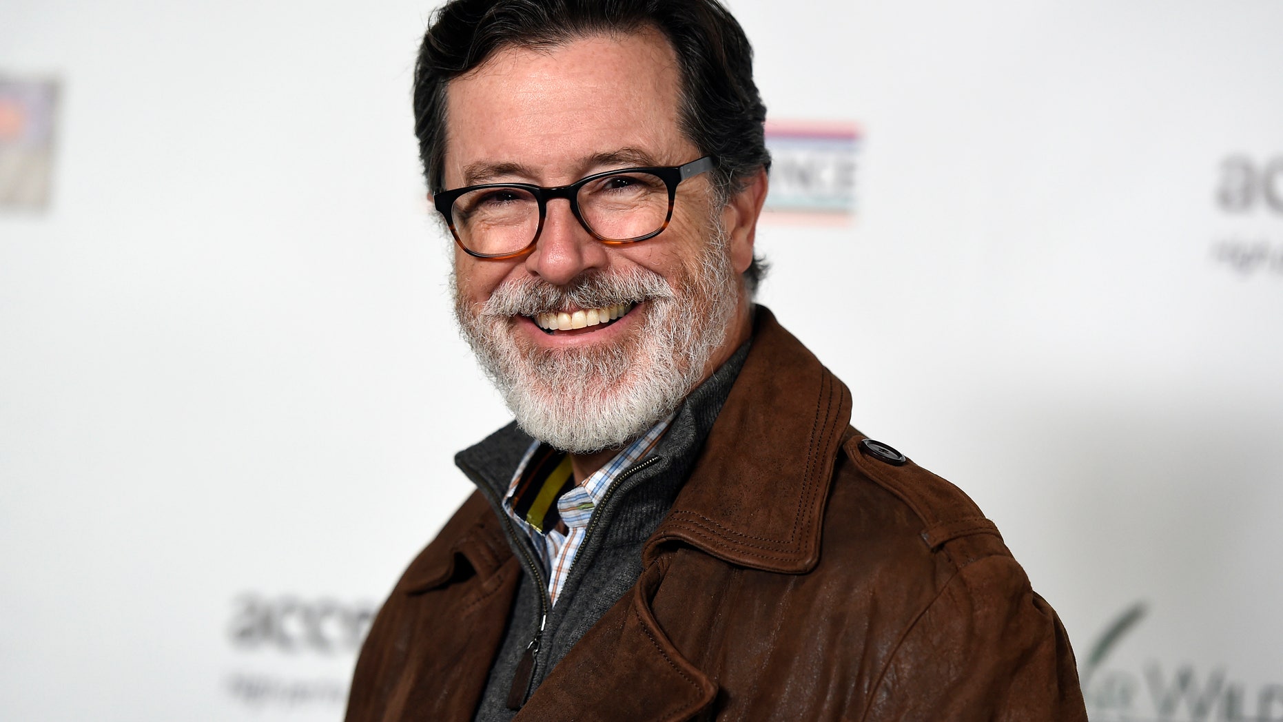 February 19, 2015. Honoree Stephen Colbert poses at the Oscar Wilde Awards at director J.J. Abrams' Bad Robot production company in Santa Monica, California.