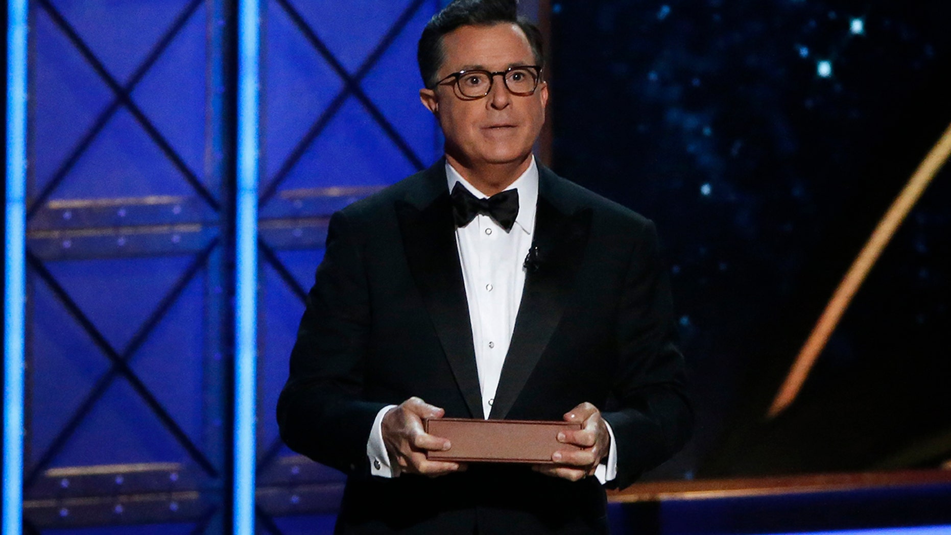 The 69th Primetime Emmy Awards Show in Los Angeles, California, Sept. 17, 2017. Host Stephen Colbert holds a book as he speaks during the show. He'll be vying for another set of media awards this year, #TheFakies Awards.