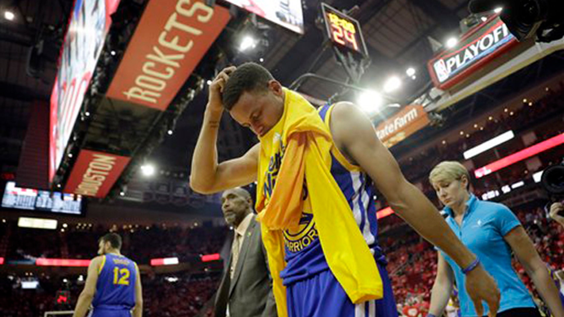Golden State Warriors' Stephen Curry heads off the court and to the locker room at the start of the second half in Game 4 of a first-round NBA basketball playoff series against the Houston Rockets, Sunday, April 24, 2016, in Houston. Curry was injured at the end of the first half. (AP Photo/David J. Phillip)