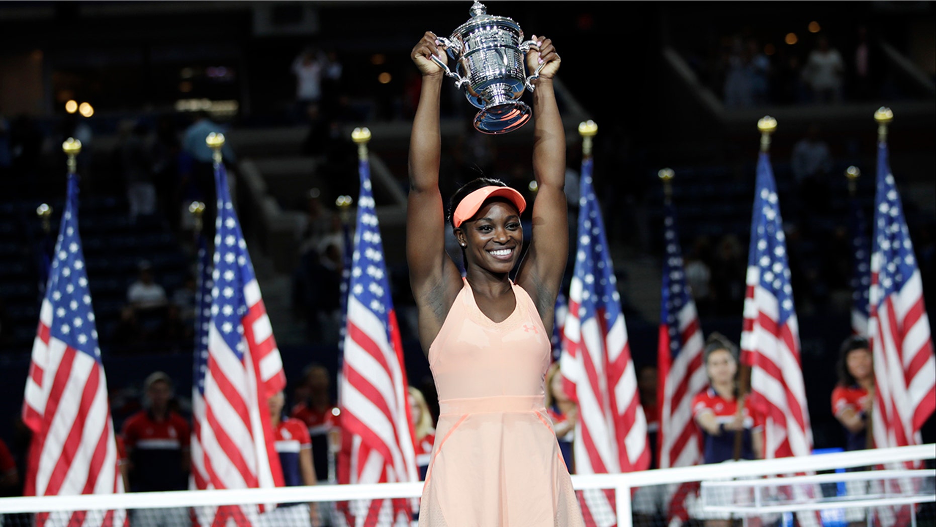Sloane Stephens, of the United States, holds up the championship trophy after beating Madison Keys, of the United States, in the women's singles final of the U.S. Open tennis tournament, Saturday, Sept. 9, 2017, in New York. (AP Photo/Julio Cortez)