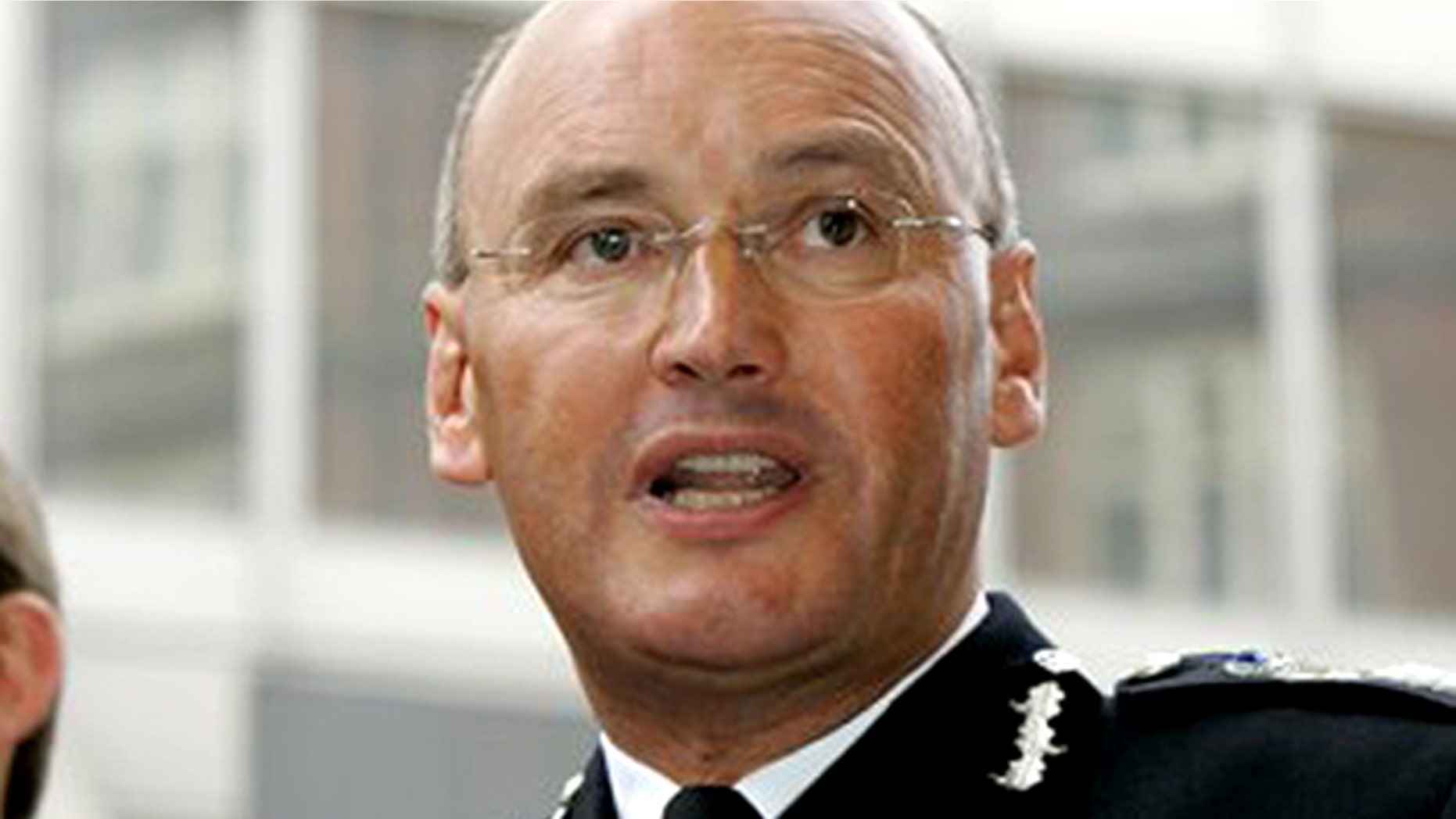 This Thursday Aug. 10, 2006 photo from files shows Sir Paul Stephenson, the Deputy Commissioner of London's Metropolitan Police Service, as he reads out a statement outside New Scotland Yard in London.