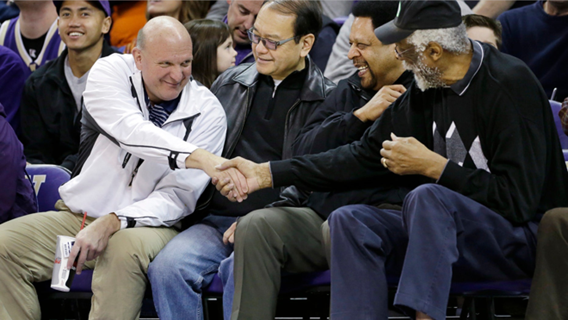 Jan. 25, 2014: In this file photo, then-Microsoft CEO Steve Ballmer, left, shakes hands with former NBA players Bill Russell, right, and "Downtown" Freddie Brown as Omar Lee looks on during an NCAA college basketball game between Washington and Oregon State in Seattle.