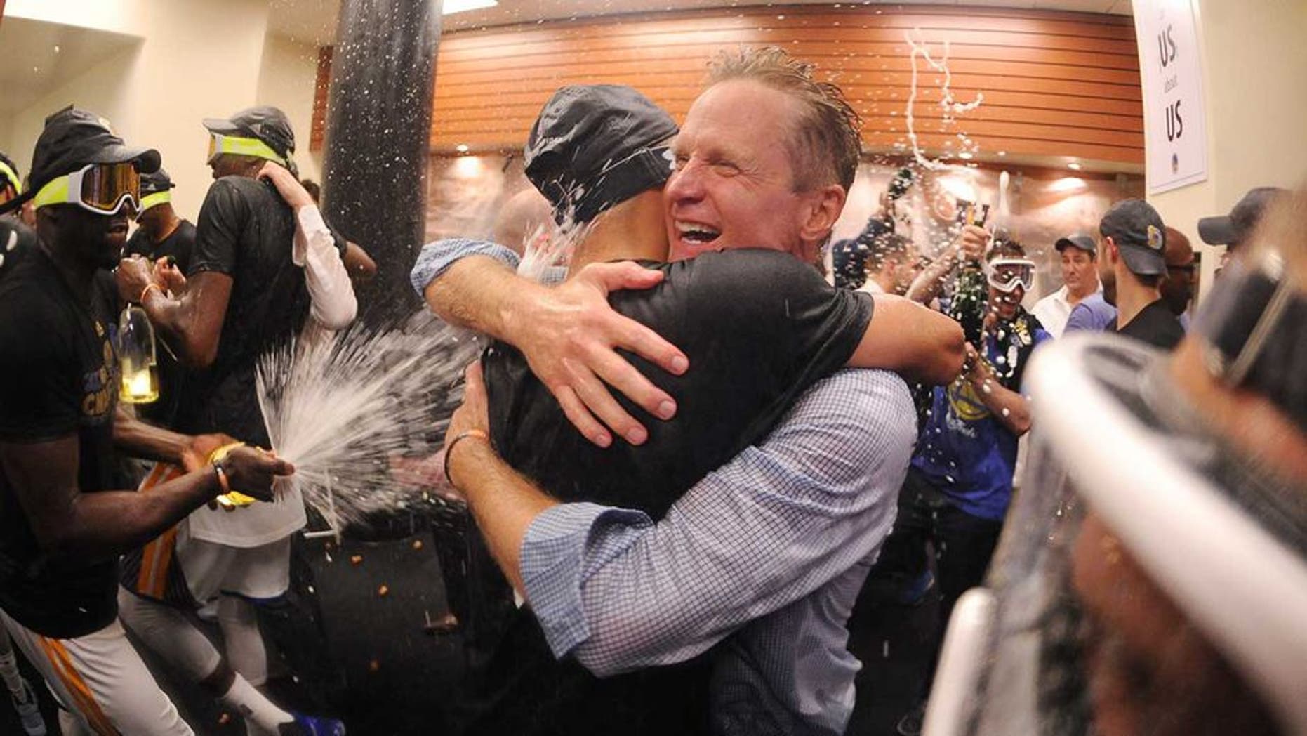 OAKLAND, CA - JUNE 12: Head Coach Steve Kerr of the Golden State Warriors celebrates in the locker room after defeating the Cleveland Cavaliers in Game Five of the 2017 NBA Finals on June 12, 2017 at Oracle Arena in Oakland, California. NOTE TO USER: User expressly acknowledges and agrees that, by downloading and or using this photograph, user is consenting to the terms and conditions of Getty Images License Agreement. Mandatory Copyright Notice: Copyright 2017 NBAE (Photo by: Noah Graham/NBAE via Getty Images)