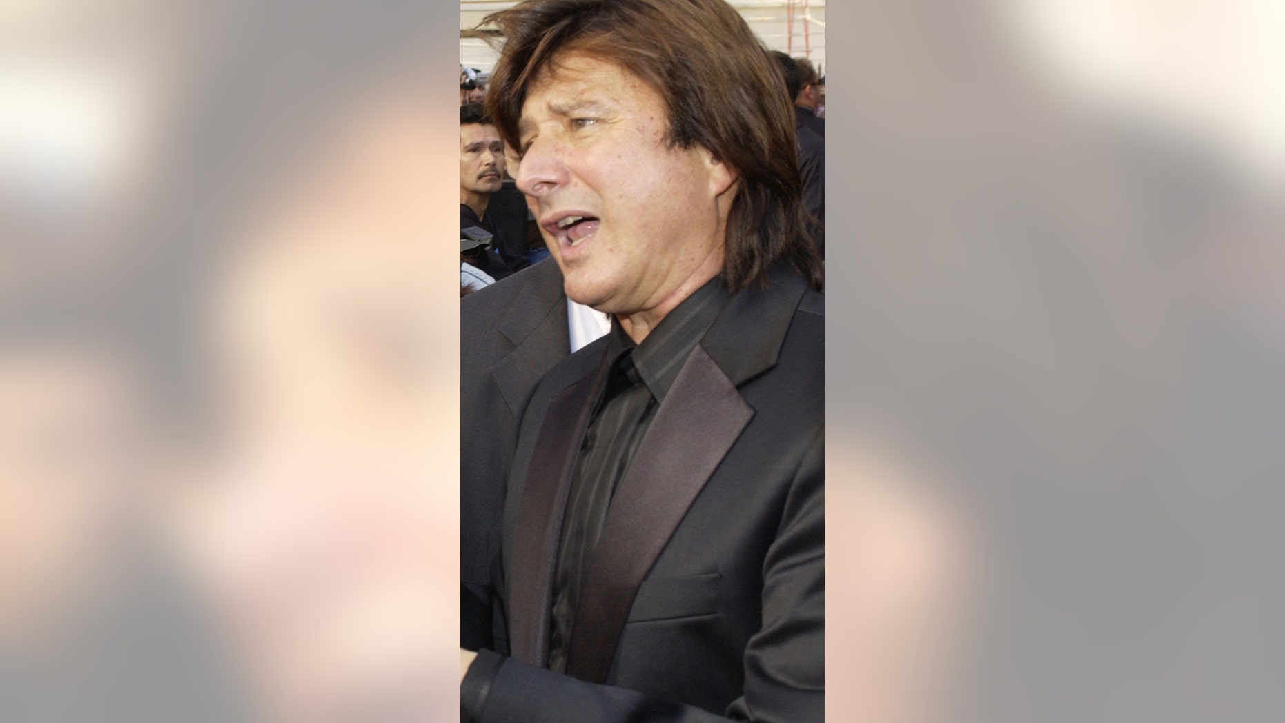 January 21, 2005. Steve Perry (R), former lead singer in the rock band Journey, signs autographs following an unveiling ceremony honoring the group with the 2,275th star on the Hollywood Walk of Fame.
