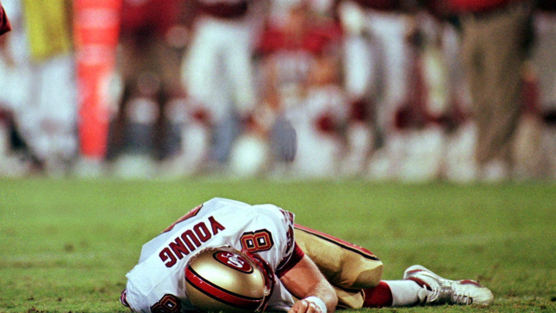 San Francisco 49ers' quarterback Steve Young lays motionless on field after suffering a concussion in the second quarter of the 49ers' game against the Arizona Cardinals Monday Sept. 27, 1999 in Tempe, Arizona.