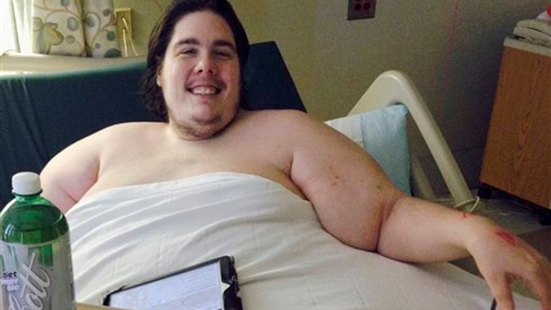 In this Monday, Oct. 12, 2015 photo, Steven Assanti, 33, rests in bed at Kent Hospital in Warwick, R.I. (AP Photo/Jennifer McDermott)
