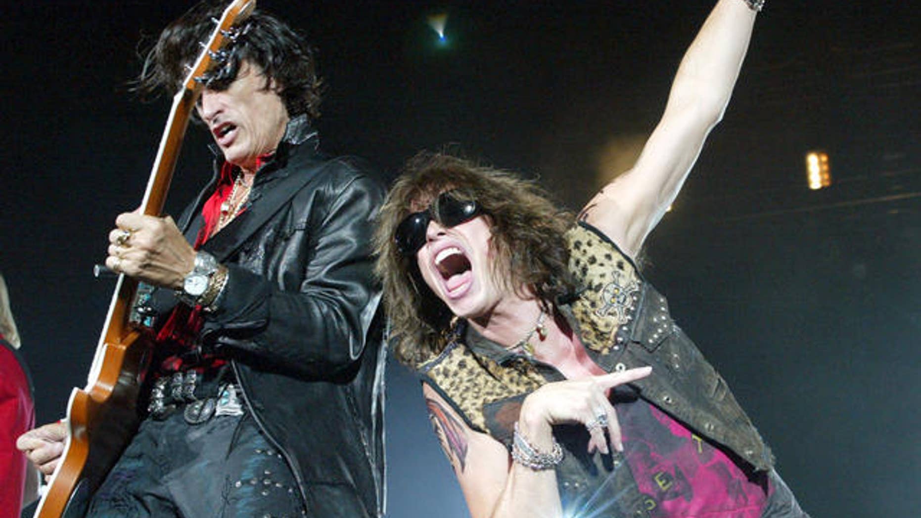 Aerosmith's lead singer Steven Tyler, right, belts out the tune beside guitarist Joe Perry during their Tokyo Dome concert in Tokyo.