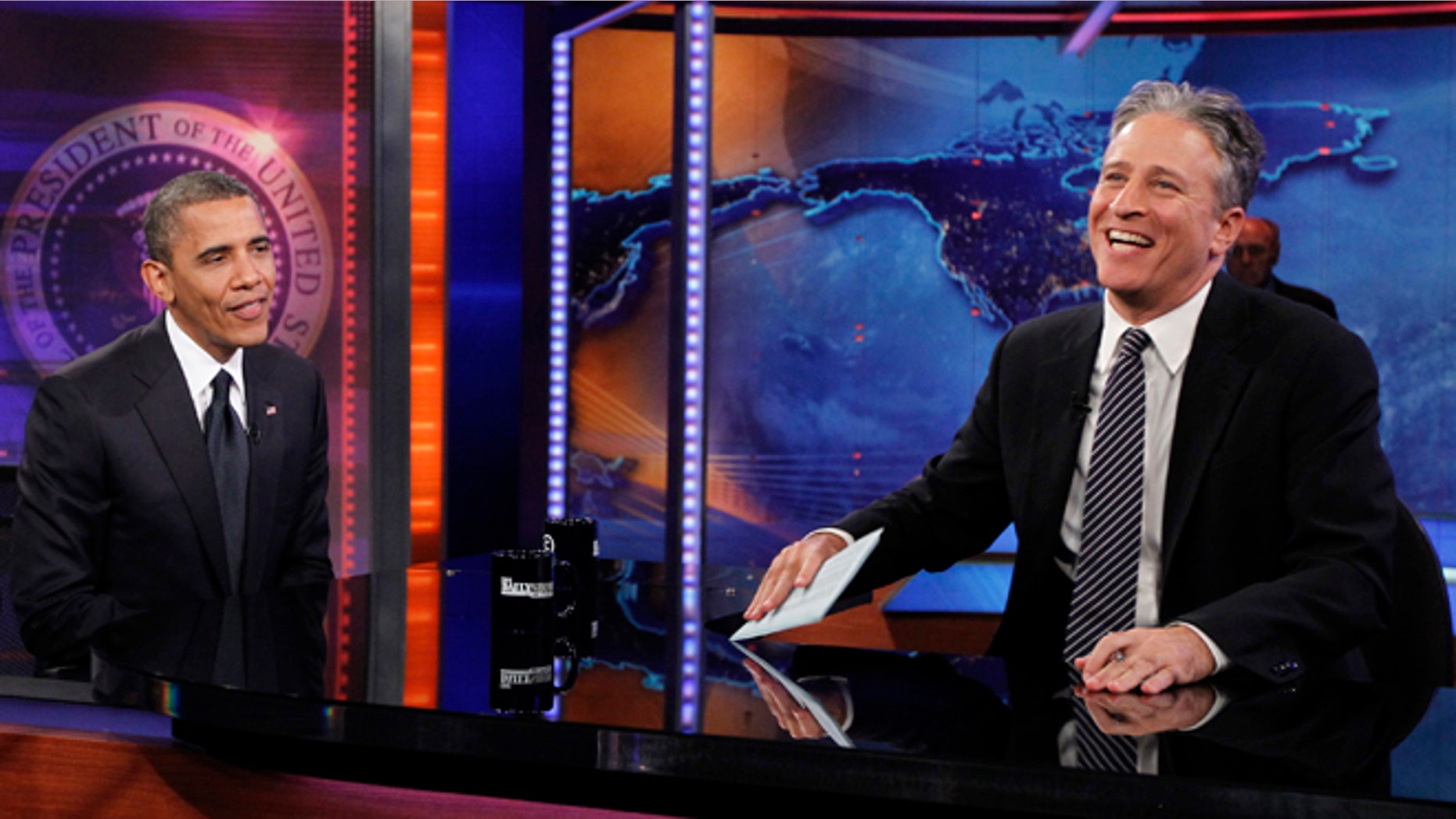 President Obama shares a laugh with 'Daily Show' host Jon Stewart in an Oct. 18, 2012 taping at Comedy Central's New York studios.