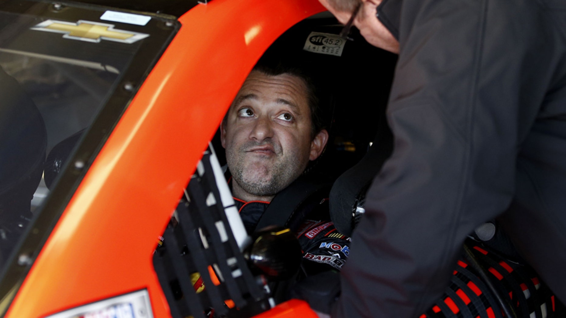 Driver Tony Stewart talks with a crew member as they get ready to practice for Sunday's NASCAR Sprint Cup series auto race at the Texas Motor Speedway in Fort Worth, Texas, Saturday, Nov. 1, 2014. AP Photo/Jim Cowsert)