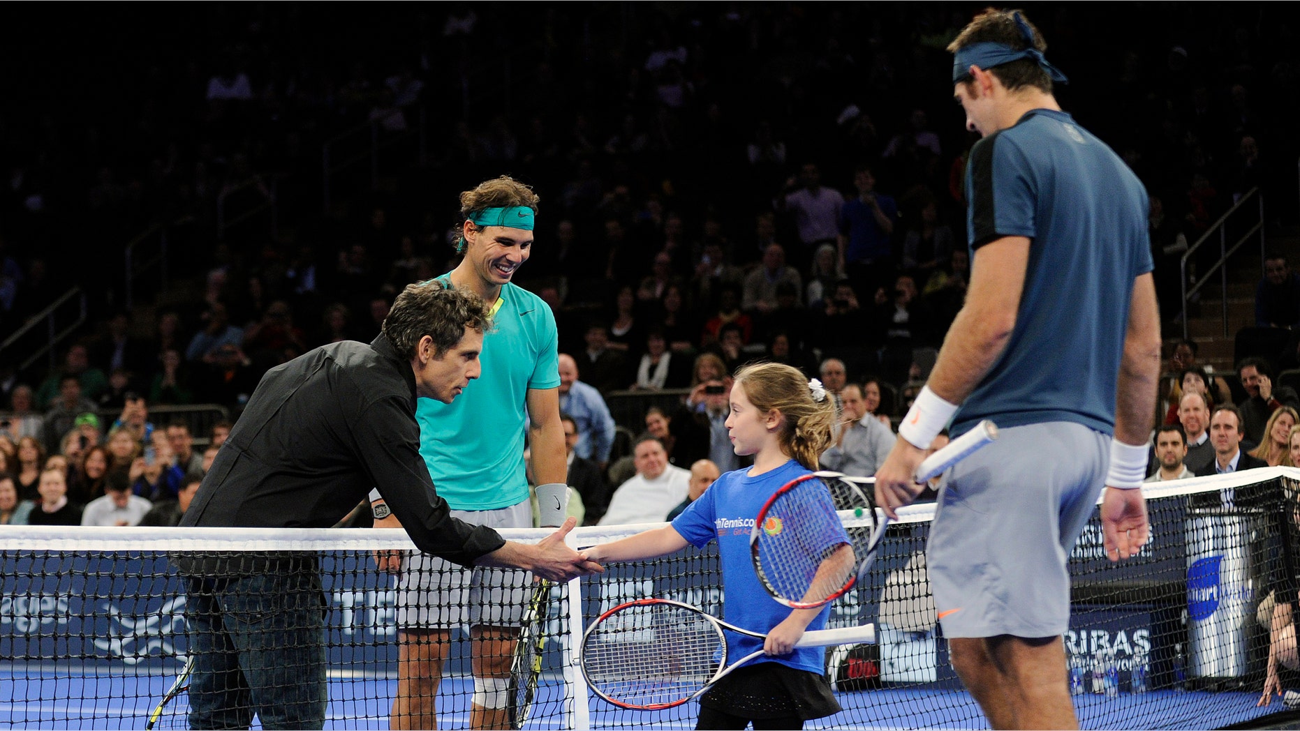 Actor Ben Stiller shakes hands with Rebecca Suarez, 9, of Huntington, N.Y. as Rafael Nadal, left, of Spain, and Juan Martin del Potro, right, of Argentina, look on during the BNP Paribas Showdown exhibition tennis match Monday, March 4, 2013, at Madison Square Garden in New York. Stiller and Suarez were invited to play during the match. (AP Photo/Bill Kostroun)