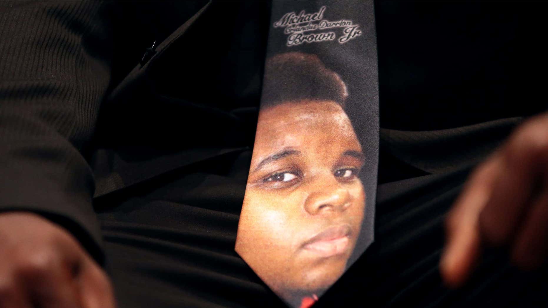 Aug. 25, 2014: A man wears a tie decorated with a picture of Michael Brown during Brown's funeral at Friendly Temple Missionary Baptist Church in St. Louis.