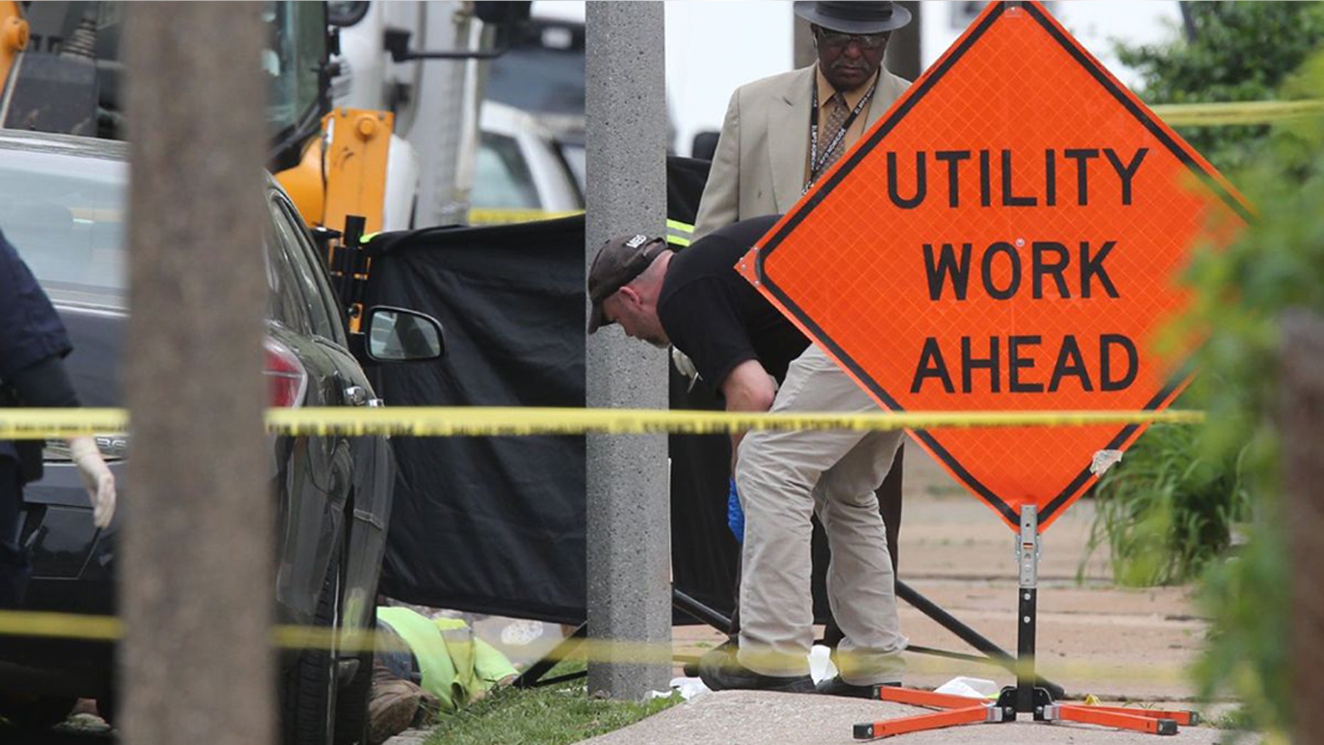 Police investigate a triple shooting in which two Laclede Gas workers were shot and killed in St. Louis on Thursday, April 20, 2017. Police say the shooter also shot and killed himself.