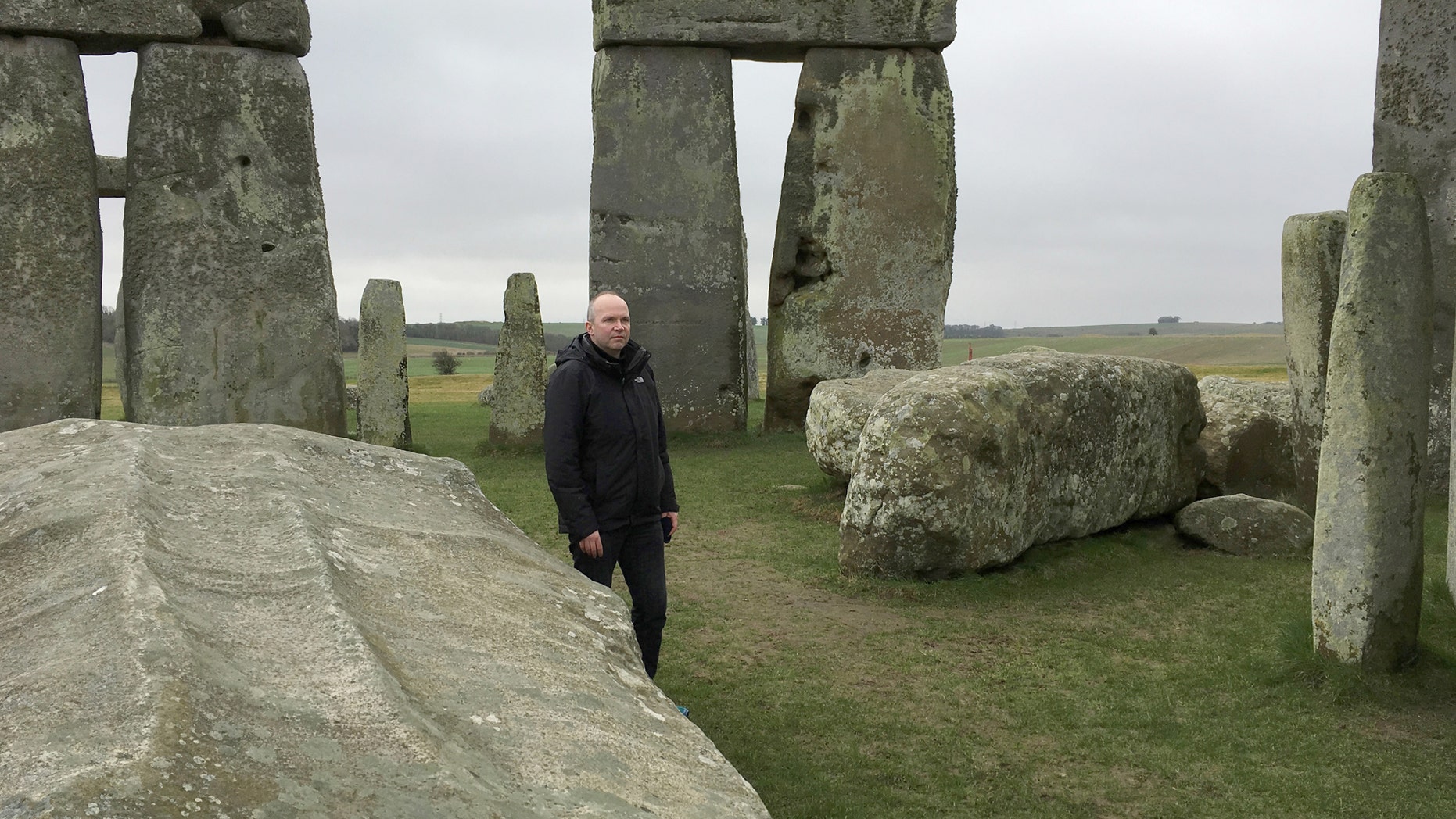 File photo: Doctor Rupert Till, music technologist from the University of Huddersfield, poses for a photograph in the stone circle of the ancient monument of Stonehenge, Amesbury, Britain February 22, 2017. Till has co-developed an app that gives users a virtual acoustic tour of Stonehenge as it would have sounded thousands of years ago with all the stones in their original place, complete with soundtrack of Neolithic 'music'. (REUTERS/Matthew Stock)