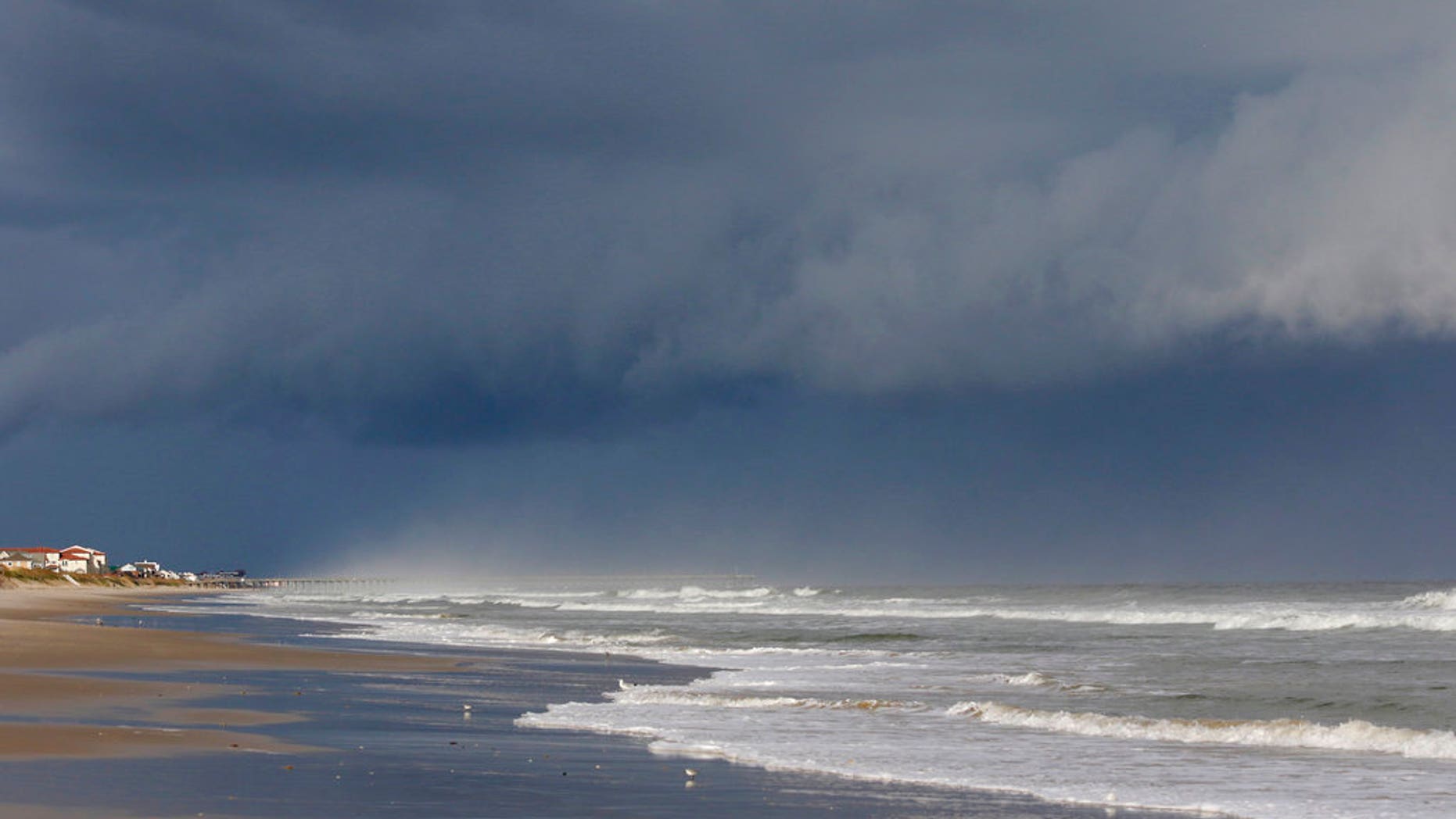 A storm front is seen on the beach in North Topsail Beach, N.C., prior to Hurricane Florence moving toward the east coast on Wednesday, Sept. 12, 2018. Hurricane Florence is putting a corridor of more than 10 million people in the crosshairs as it closes in on the Carolinas, uncertainty over its projected path spreading worry across a wider swath of the Southeast. (AP Photo/Tom Copeland)